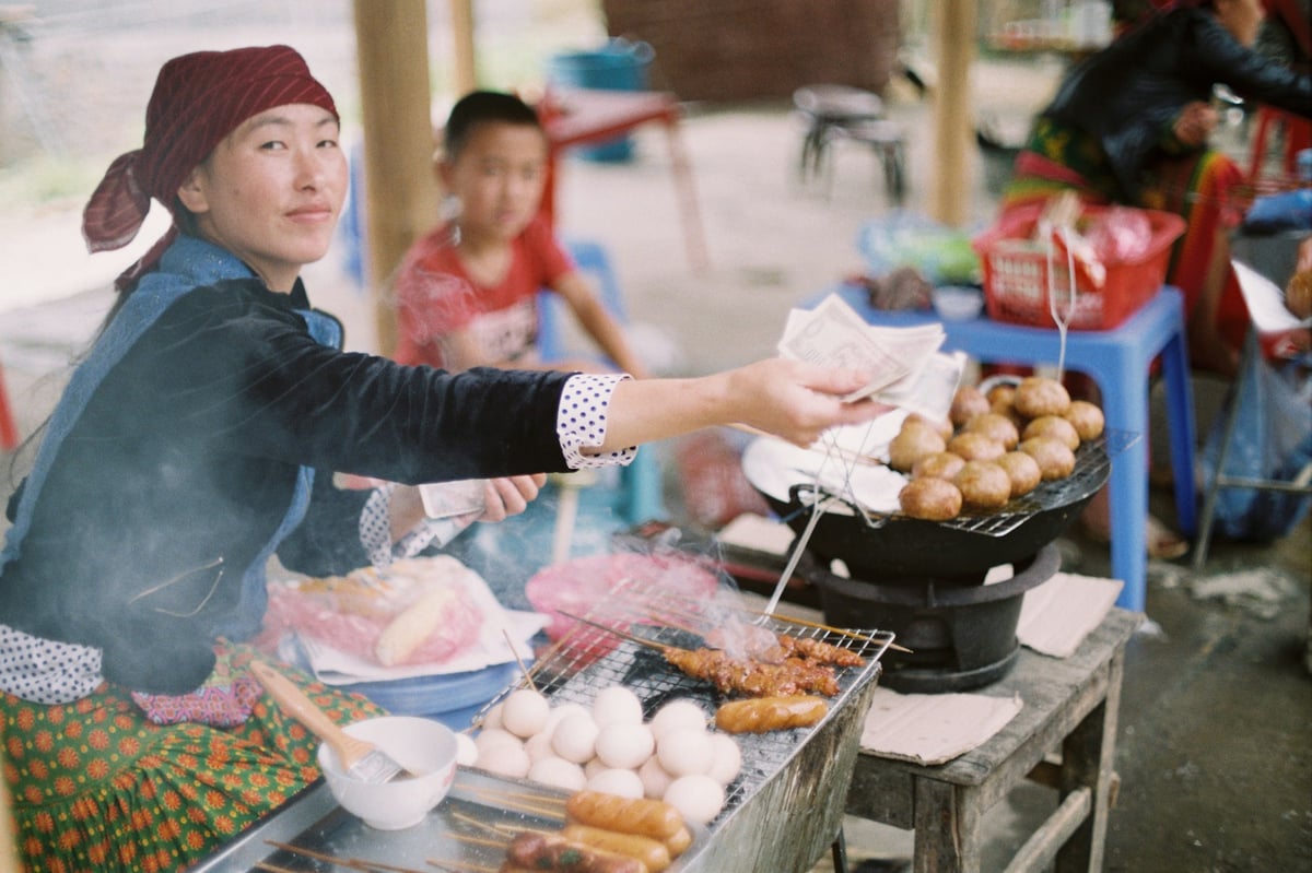 Food being cooked to order over a wok at a Vietnamese street stall