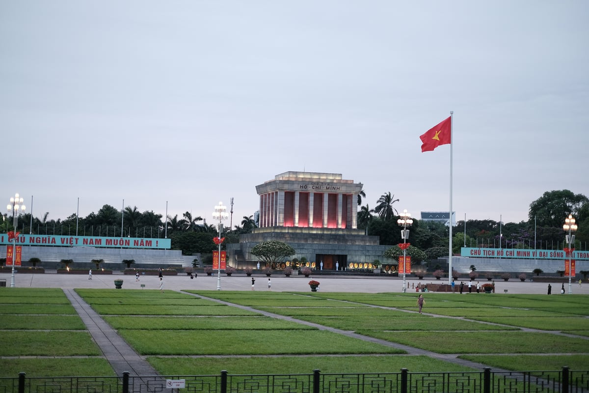 The Ho Chi Minh Mausoleum across the lawns of Ba Dinh Square in Hanoi, with a Vietnamese flag
