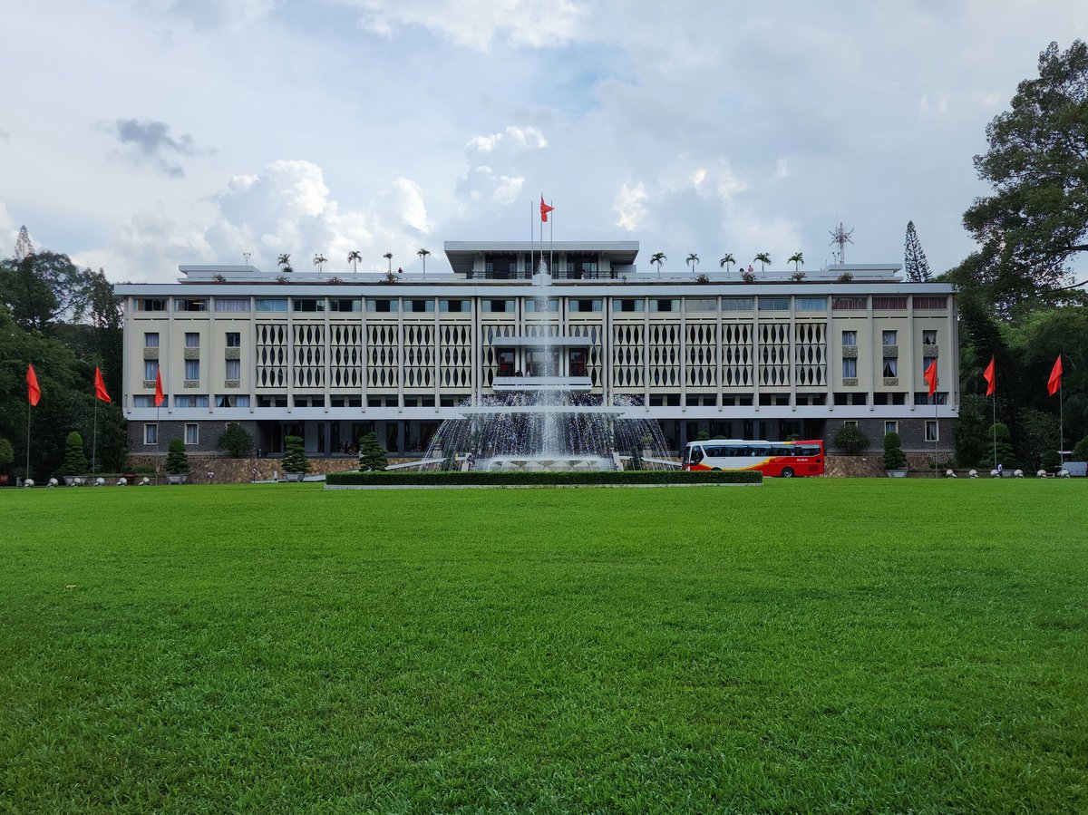 The Reunification Palace in Ho Chi Minh City, seen across its lawn with the fountain in front