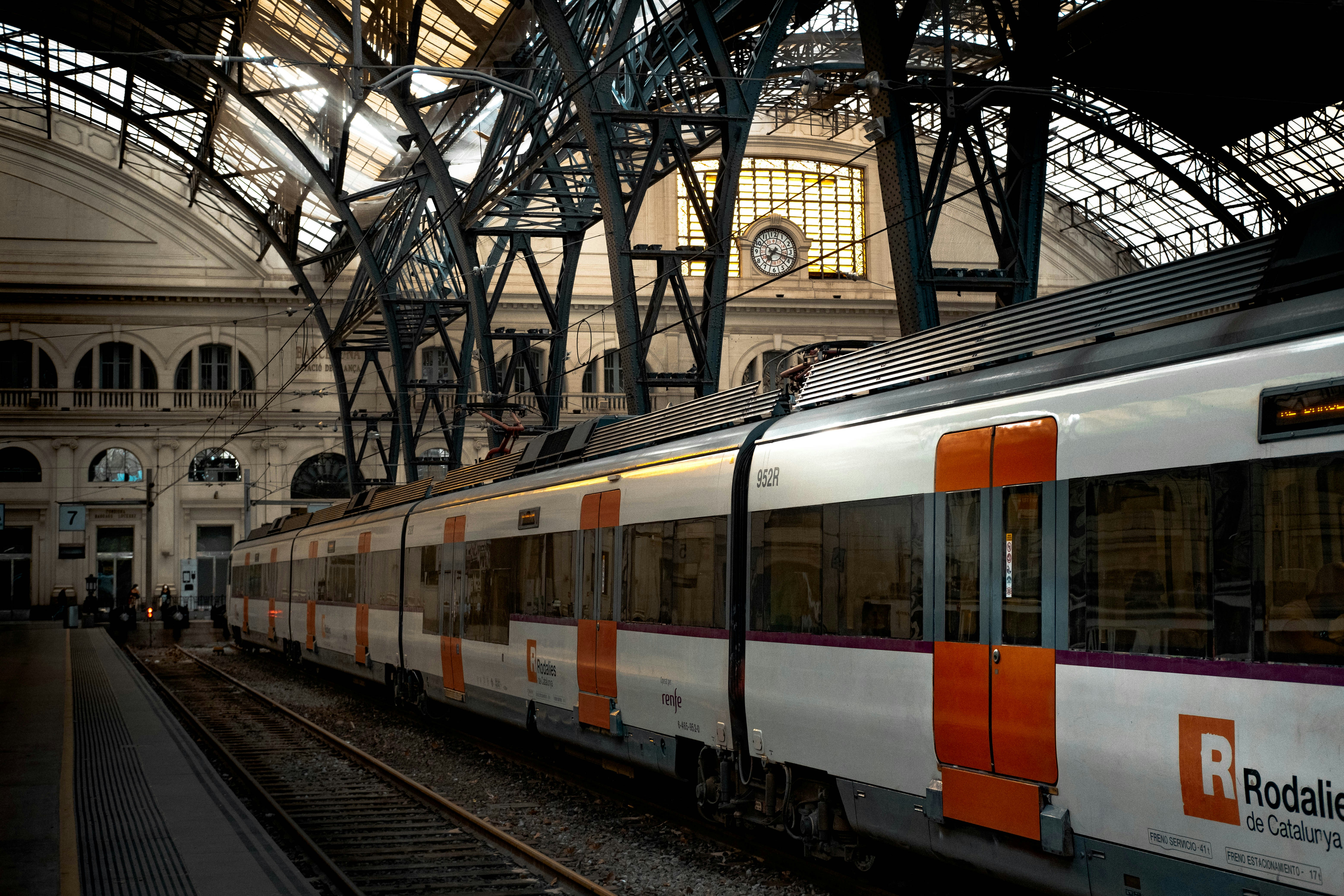 R2 Rodalies train at the airport station platform, or the Aerobús interior with luggage racks