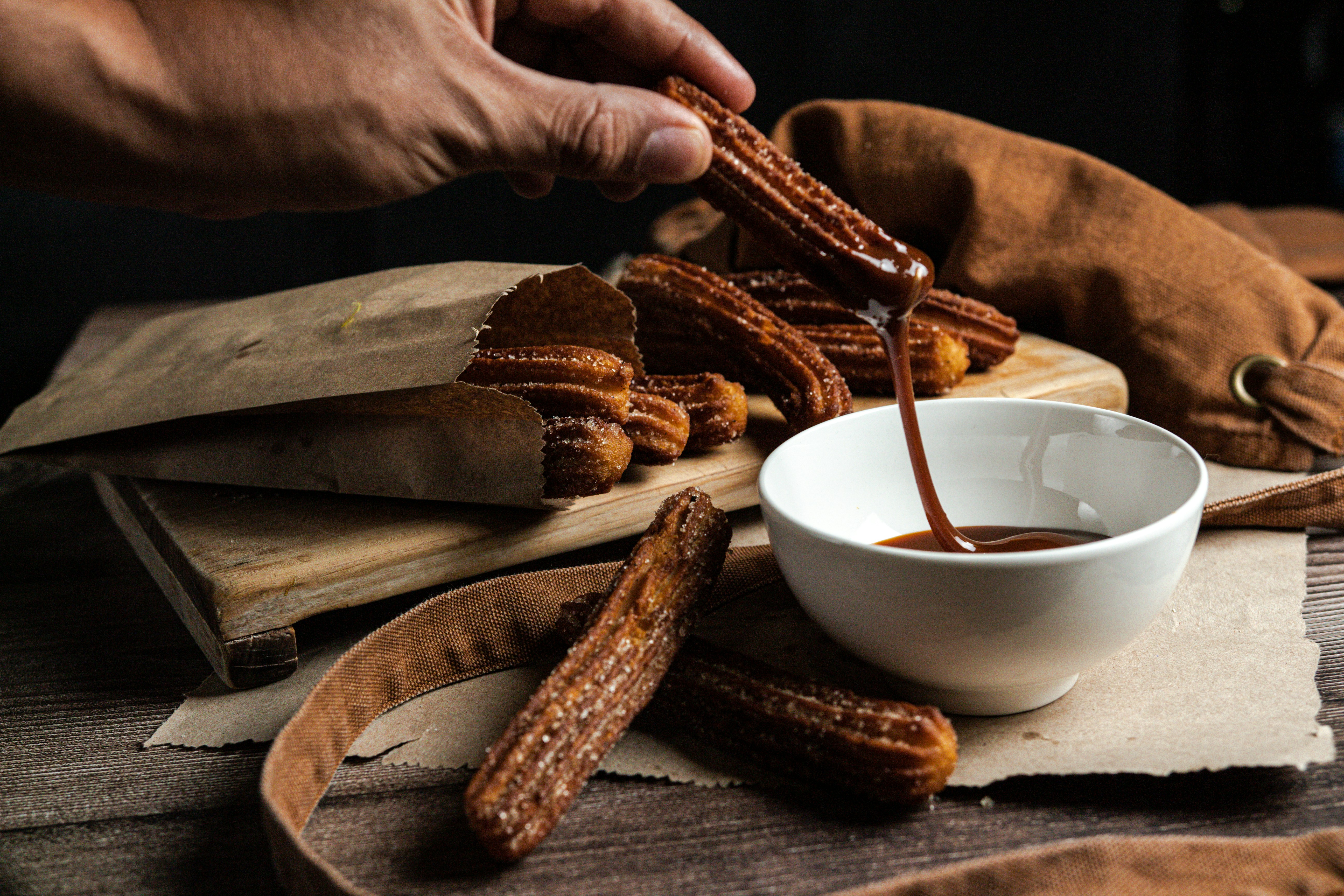 A cortado or café con leche on a café table, or a churros-and-chocolate scene