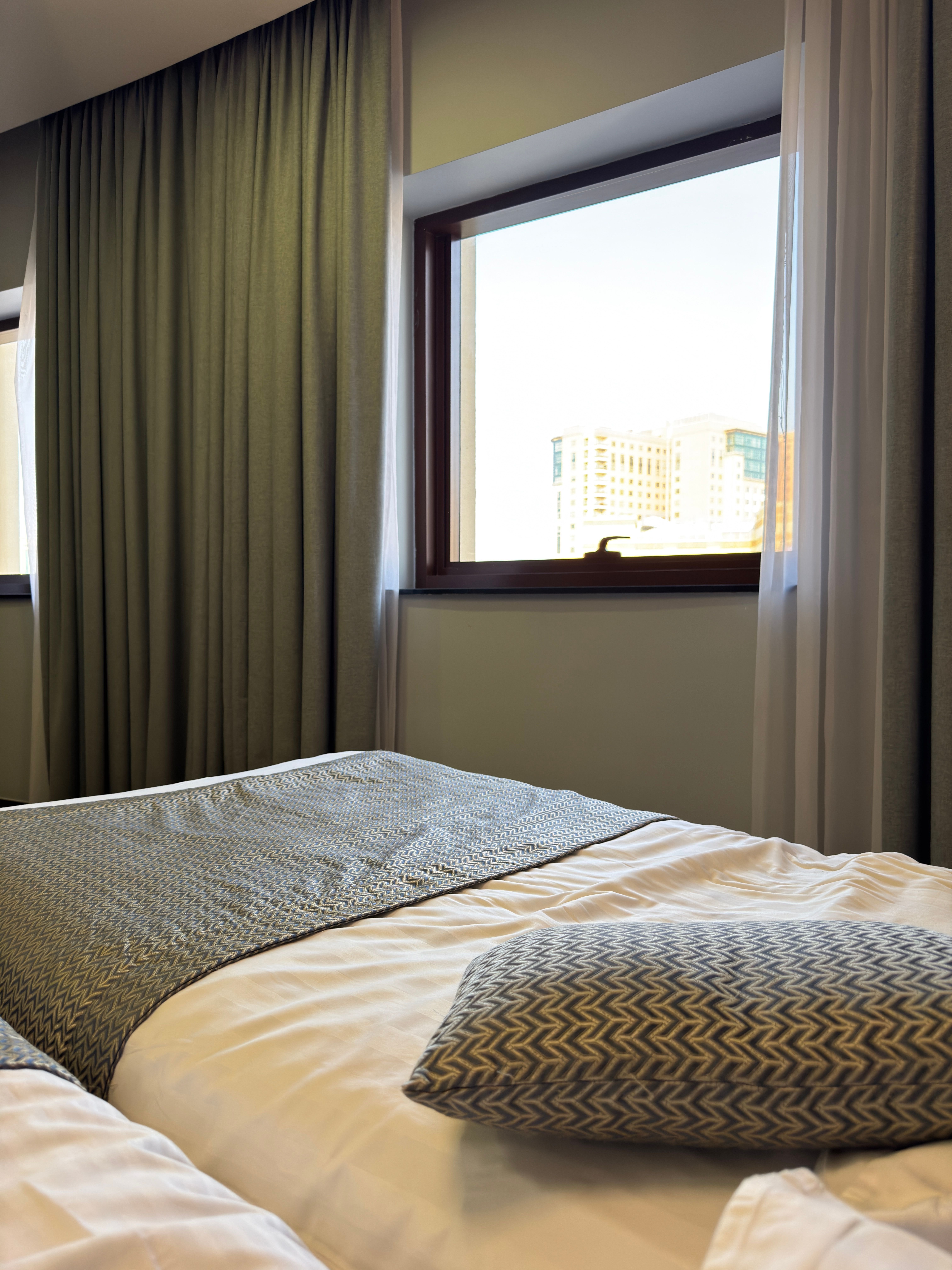 A bright, design-forward hostel common room or a simple stylish budget hotel room in Barcelona