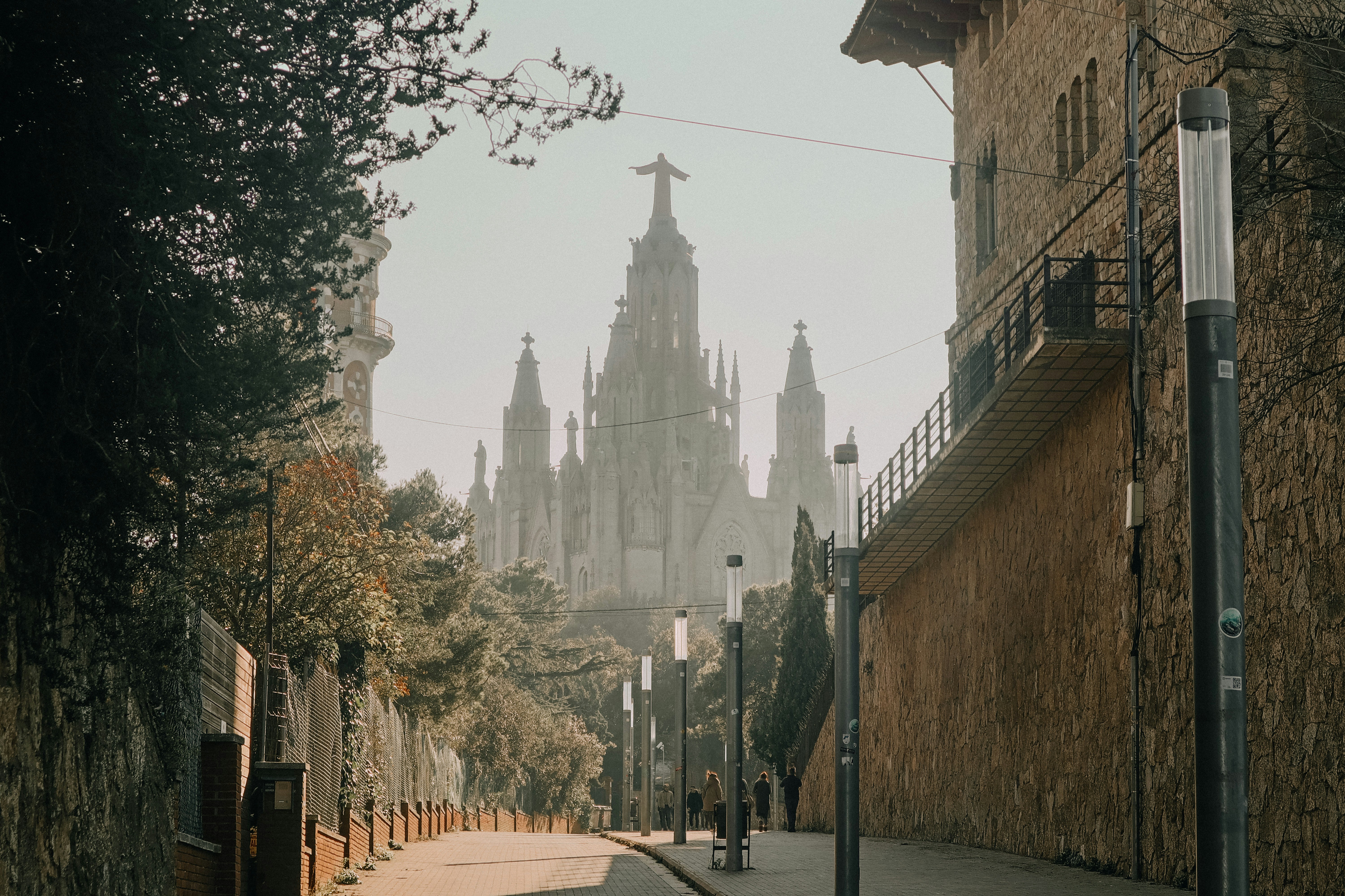 A relaxed first-day Barcelona scene — a sunny plaça, a café terrace, or a gentle stroll down a tree-lined street