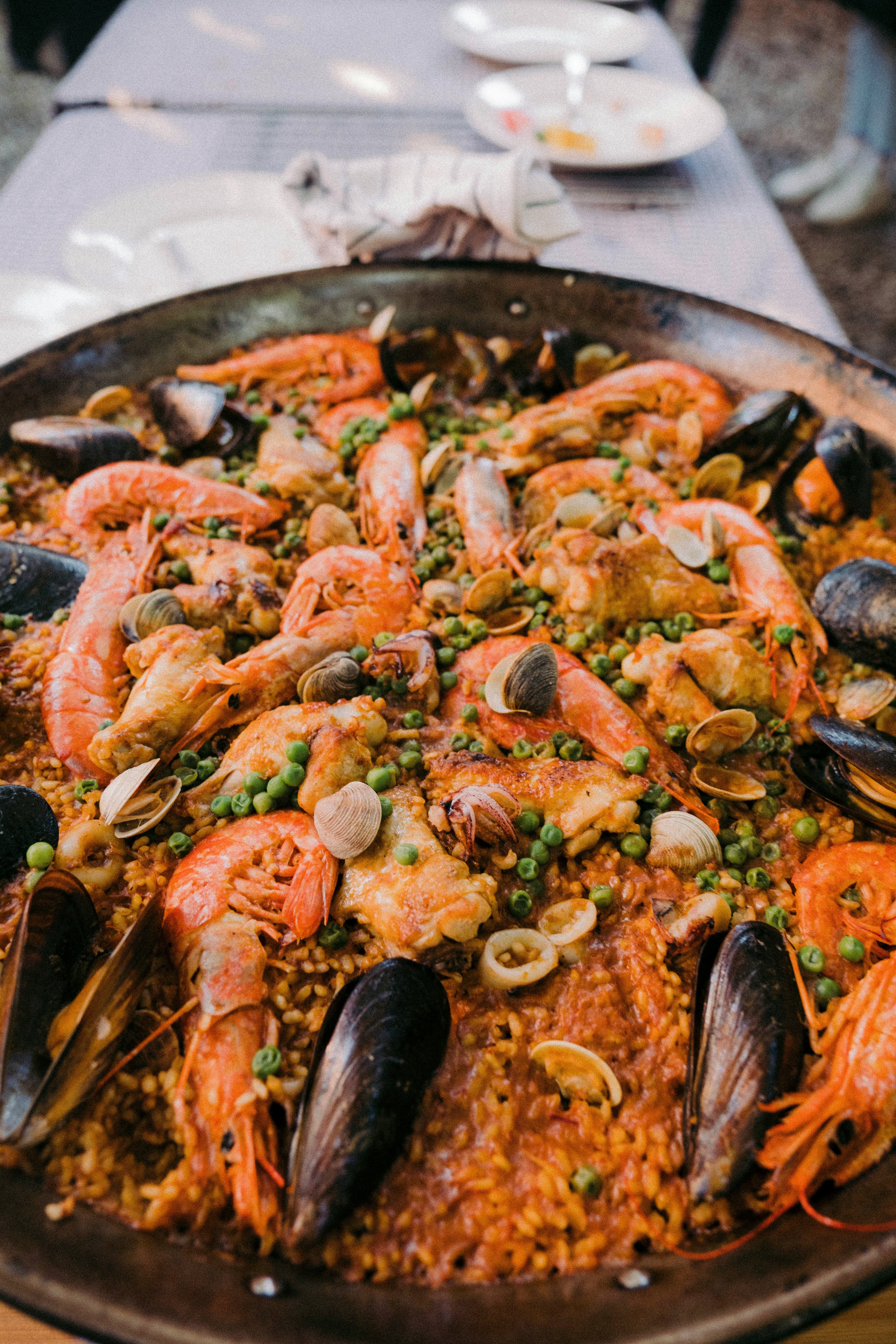 A cooking class in action (paella pan) or a market tour with a guide