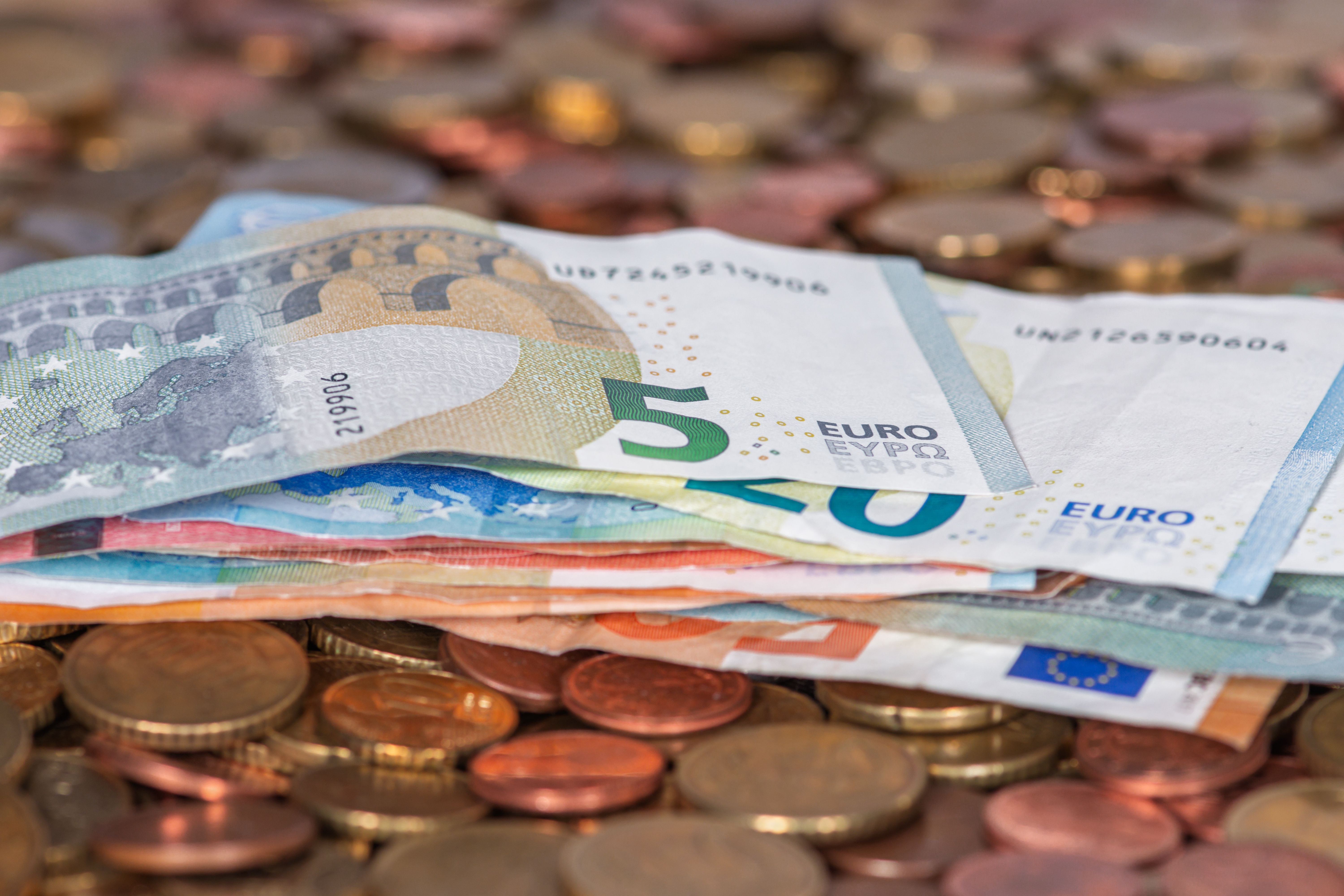 A contactless card payment at a Barcelona café, or euro notes and coins with a coffee