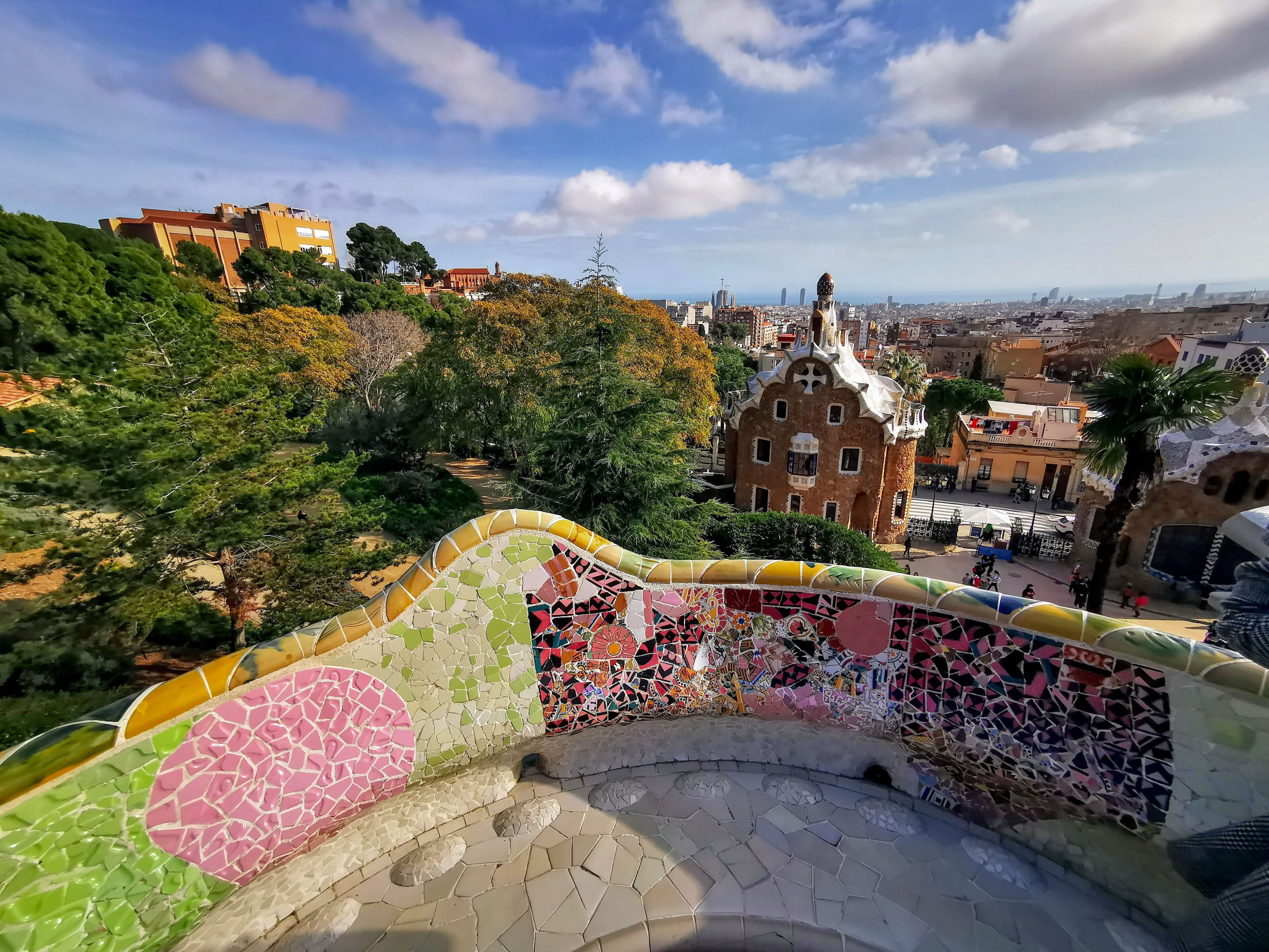 The serpentine trencadís bench on the main terrace with the city and sea in the background