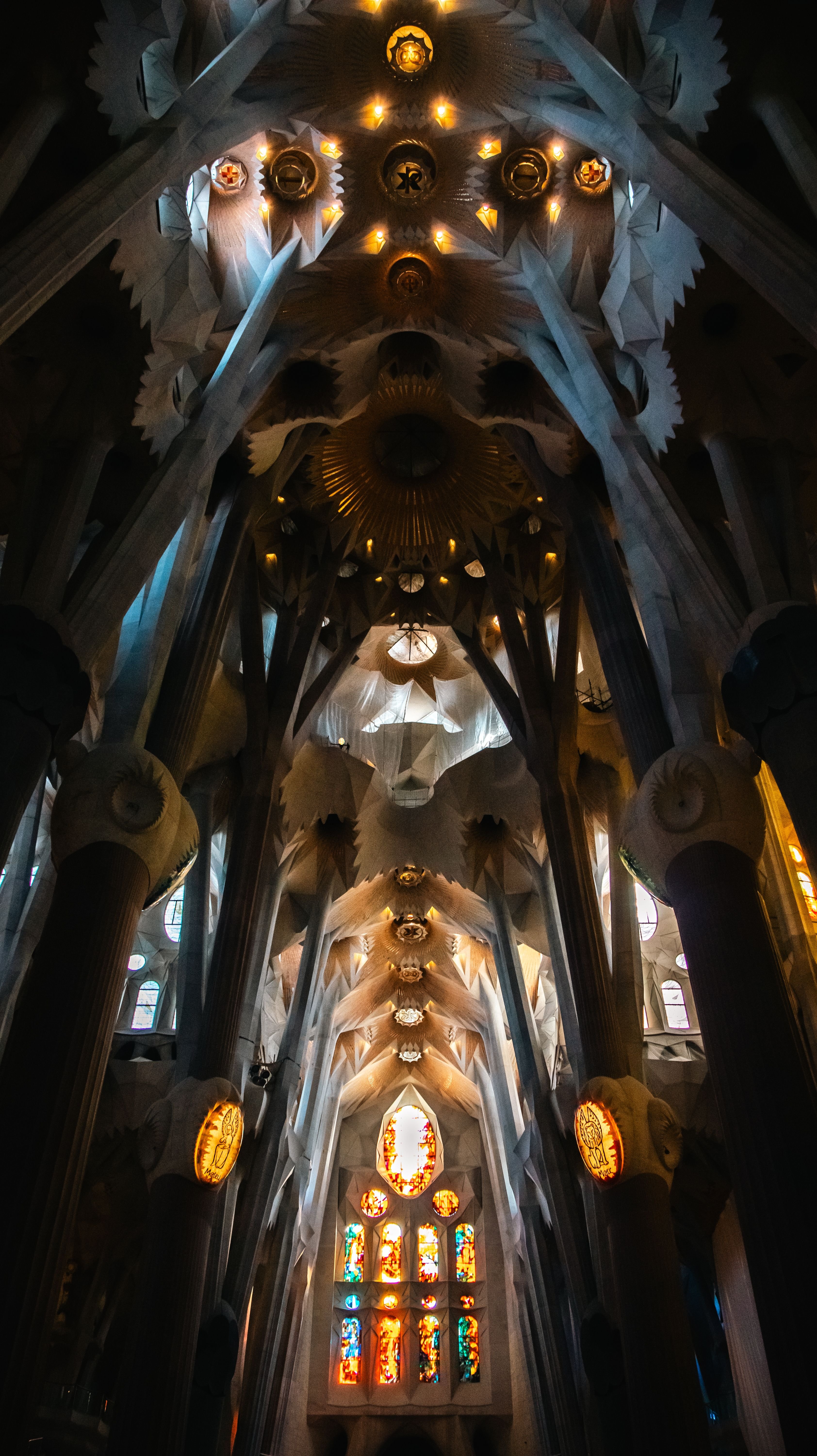 Interior nave with the tree-like columns and stained glass light, no people prominent