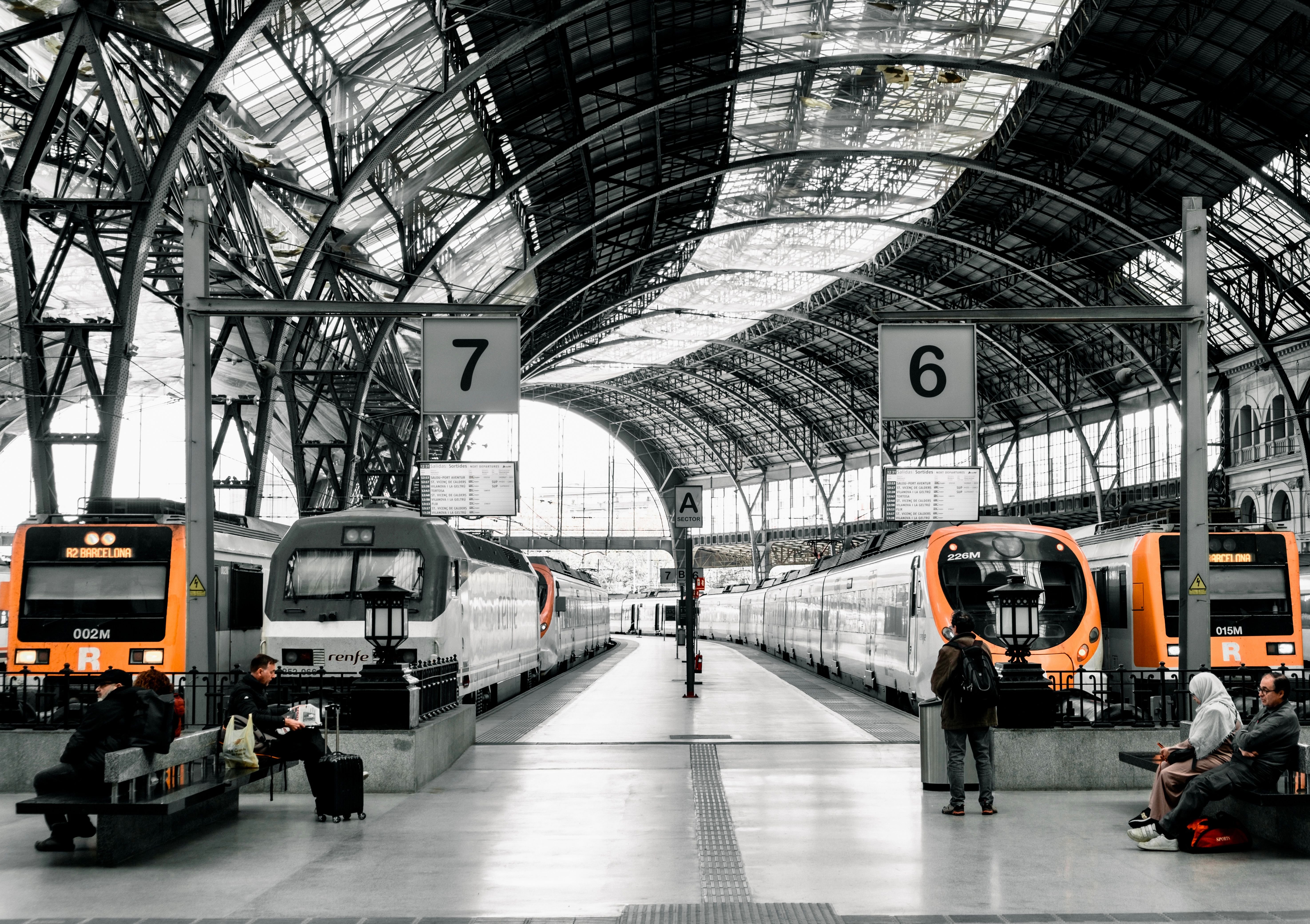 A sleek Spanish high-speed train at a platform, or the Barcelona Sants concourse