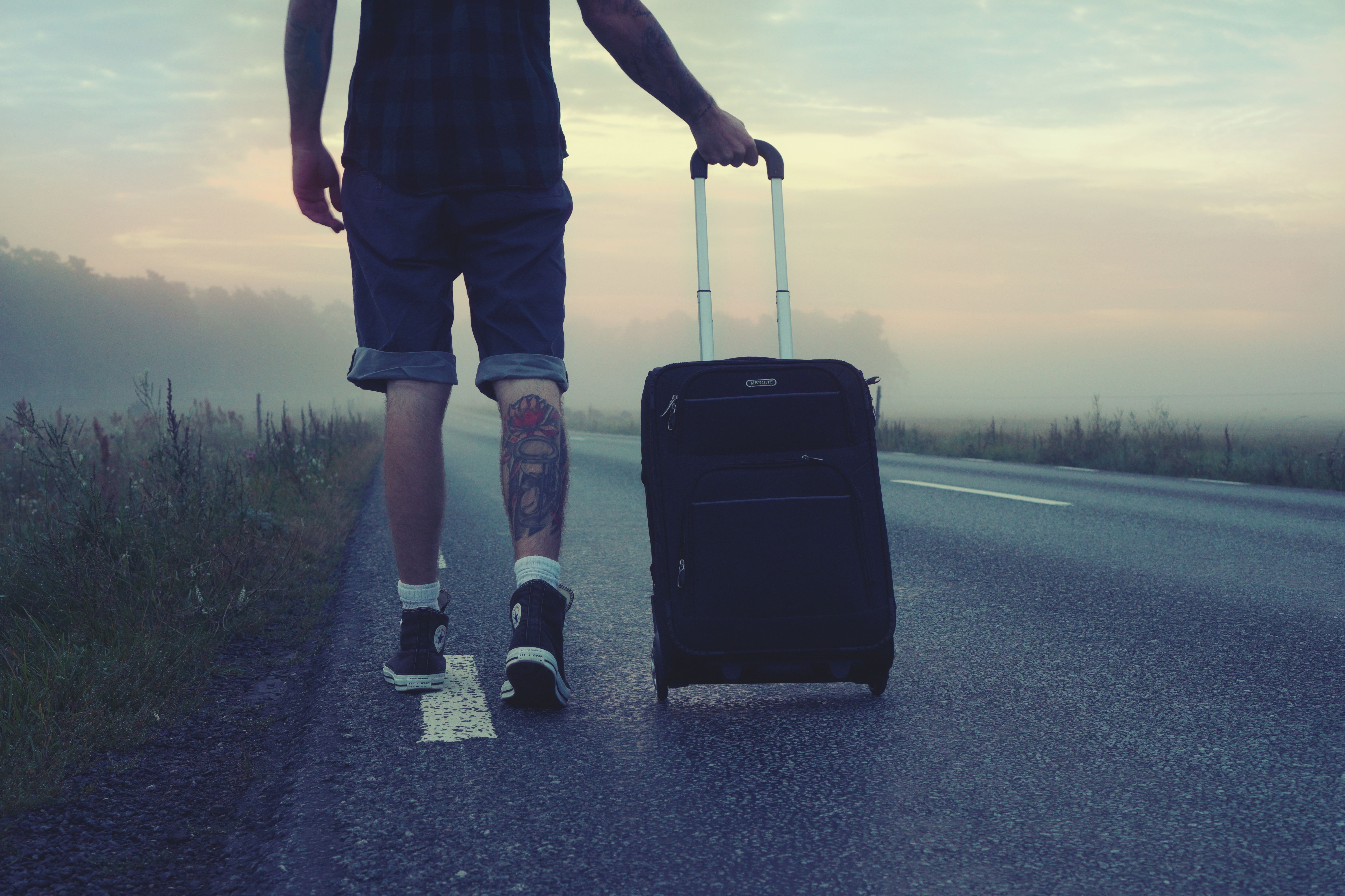 A traveler with luggage / passport and documents, or a reassuring travel-planning flat-lay