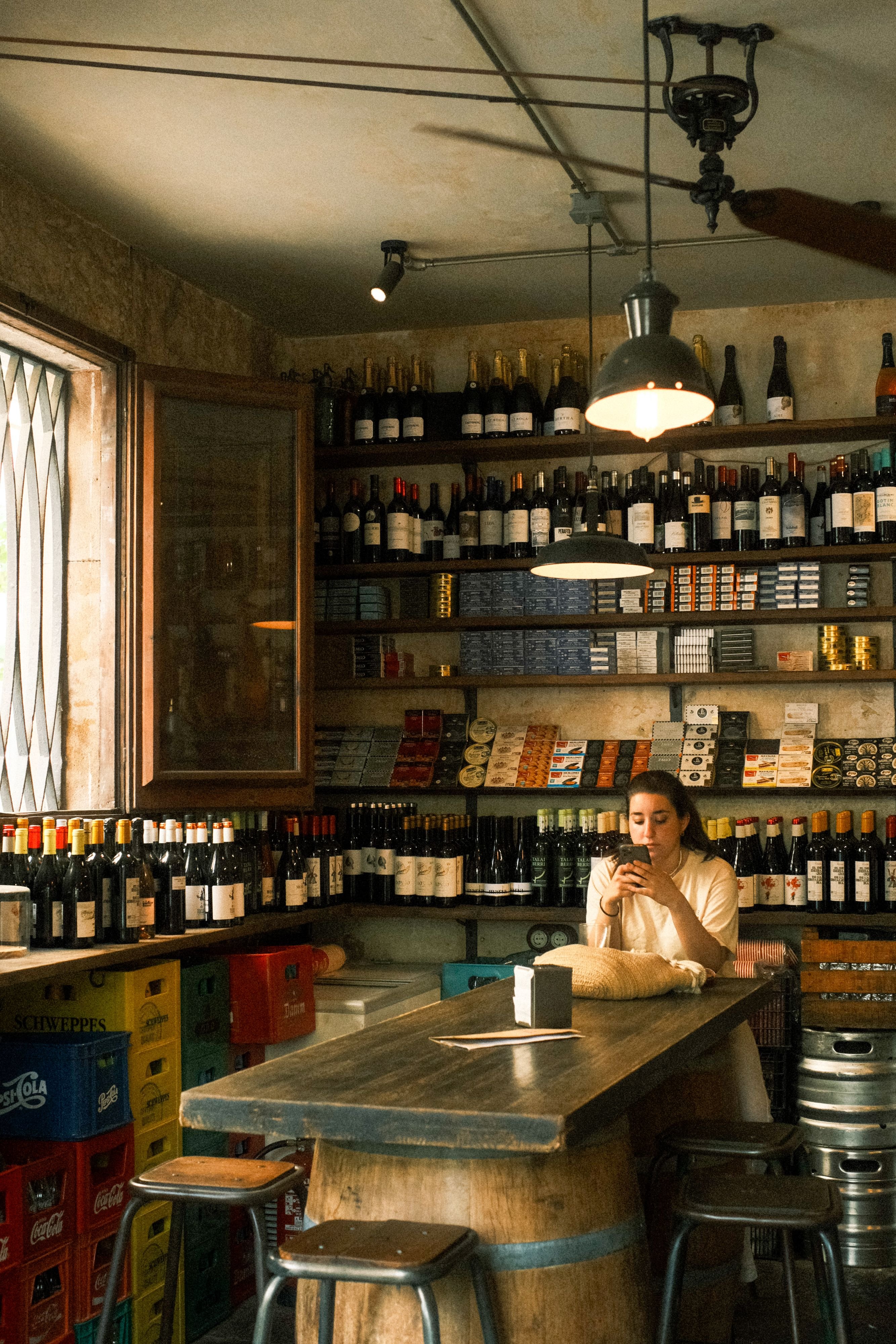 A cava bottle and glasses, or wine being poured at a tapas bar