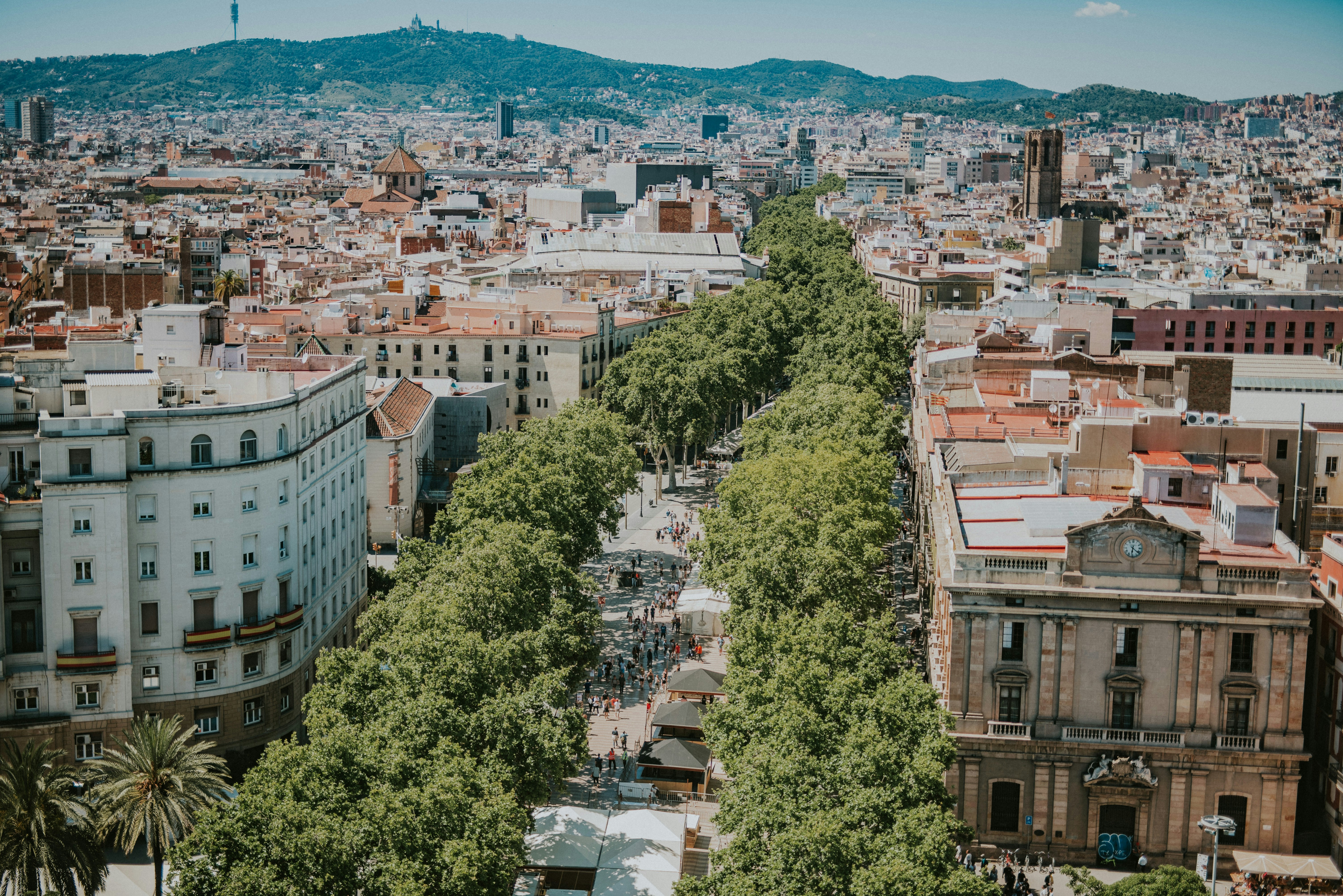 A seasonal Barcelona scene — sunny beach summer, or a layered-up café terrace in cooler weather
