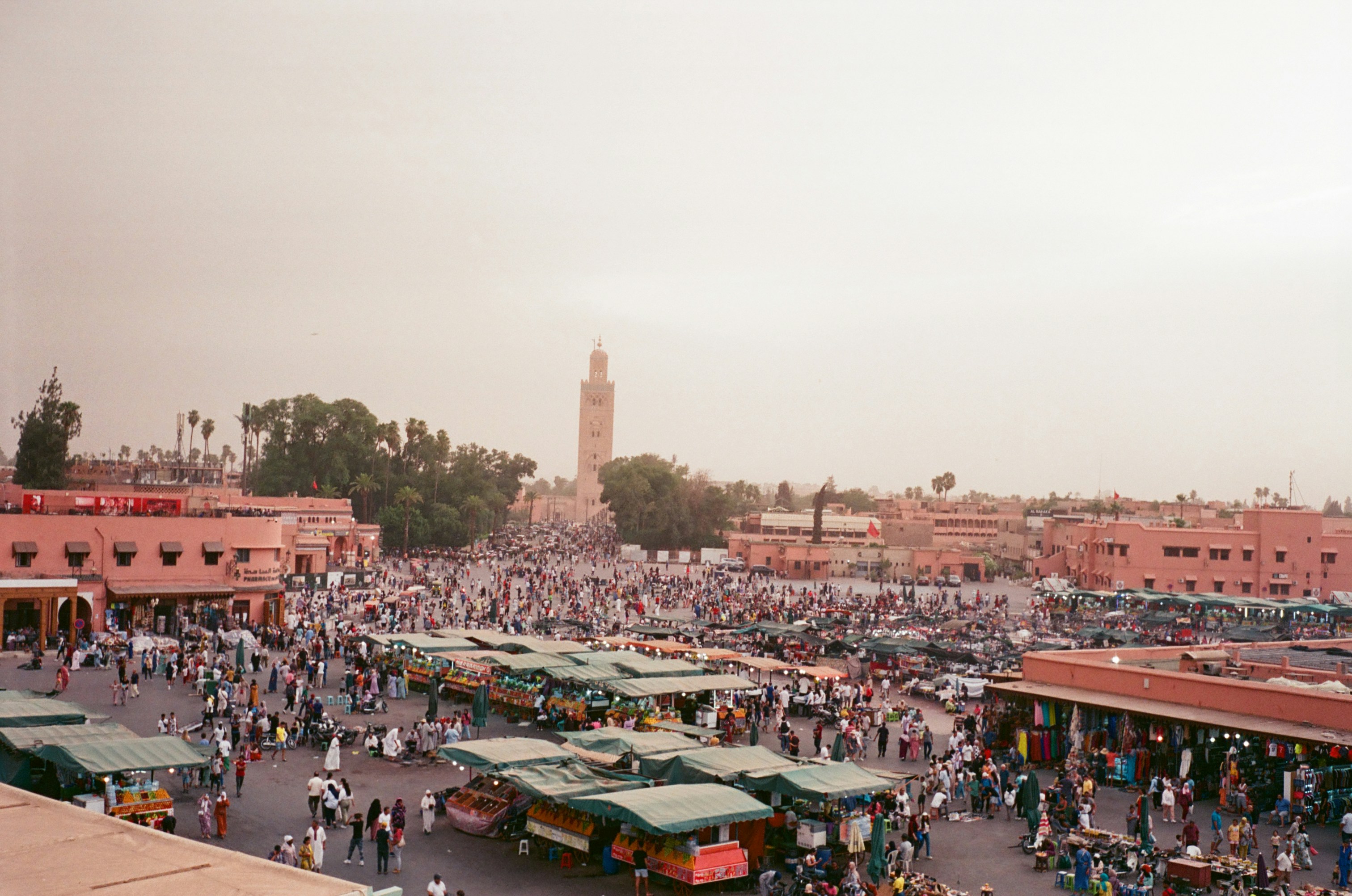 Jemaa el-Fnaa square in Marrakech at dusk with food stalls and the Koutoubia minaret behind