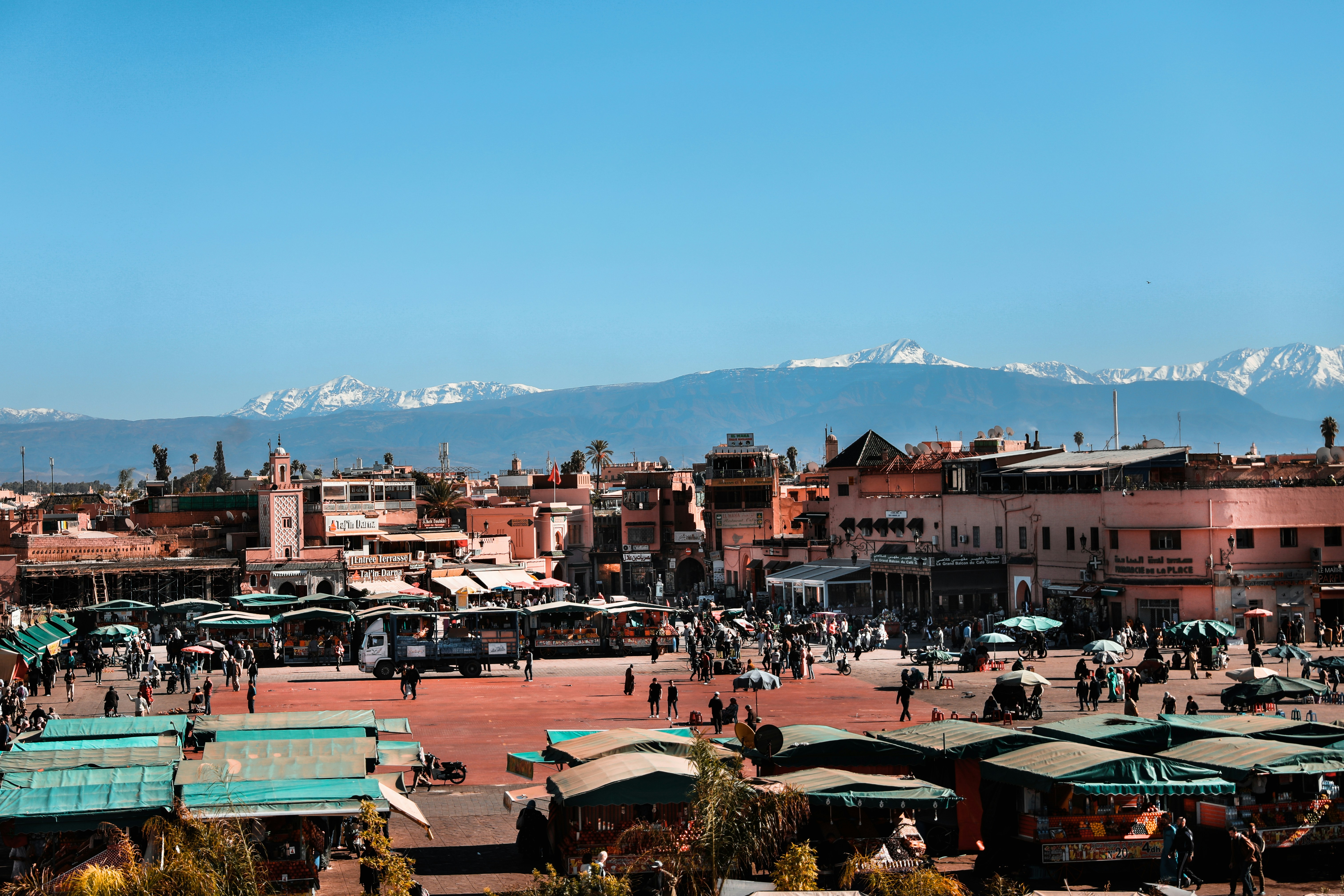 Aerial view of Marrakech medina rooftops with the Atlas Mountains behind