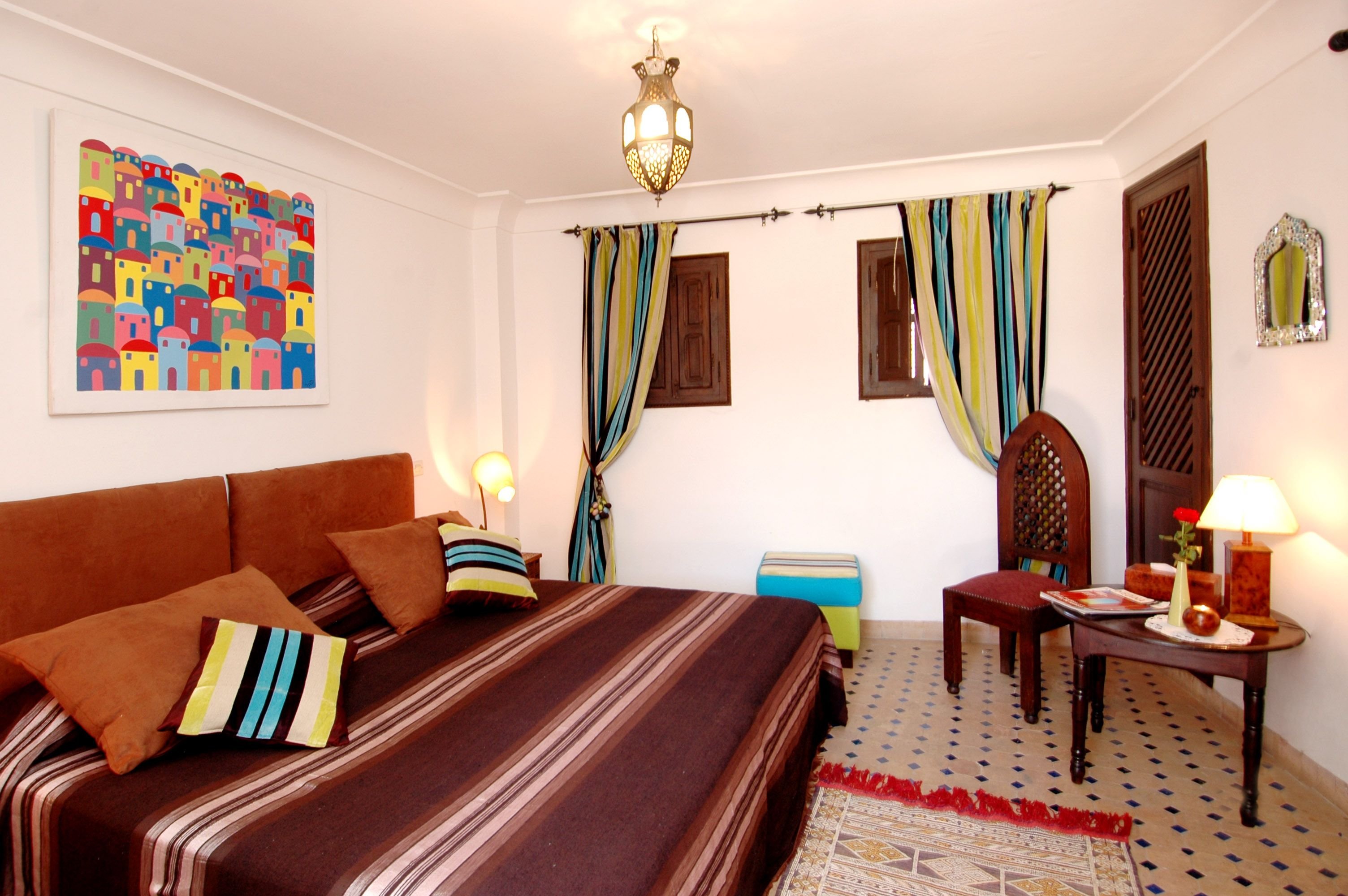 A mid-range riad room with traditional decor and a comfortable bed