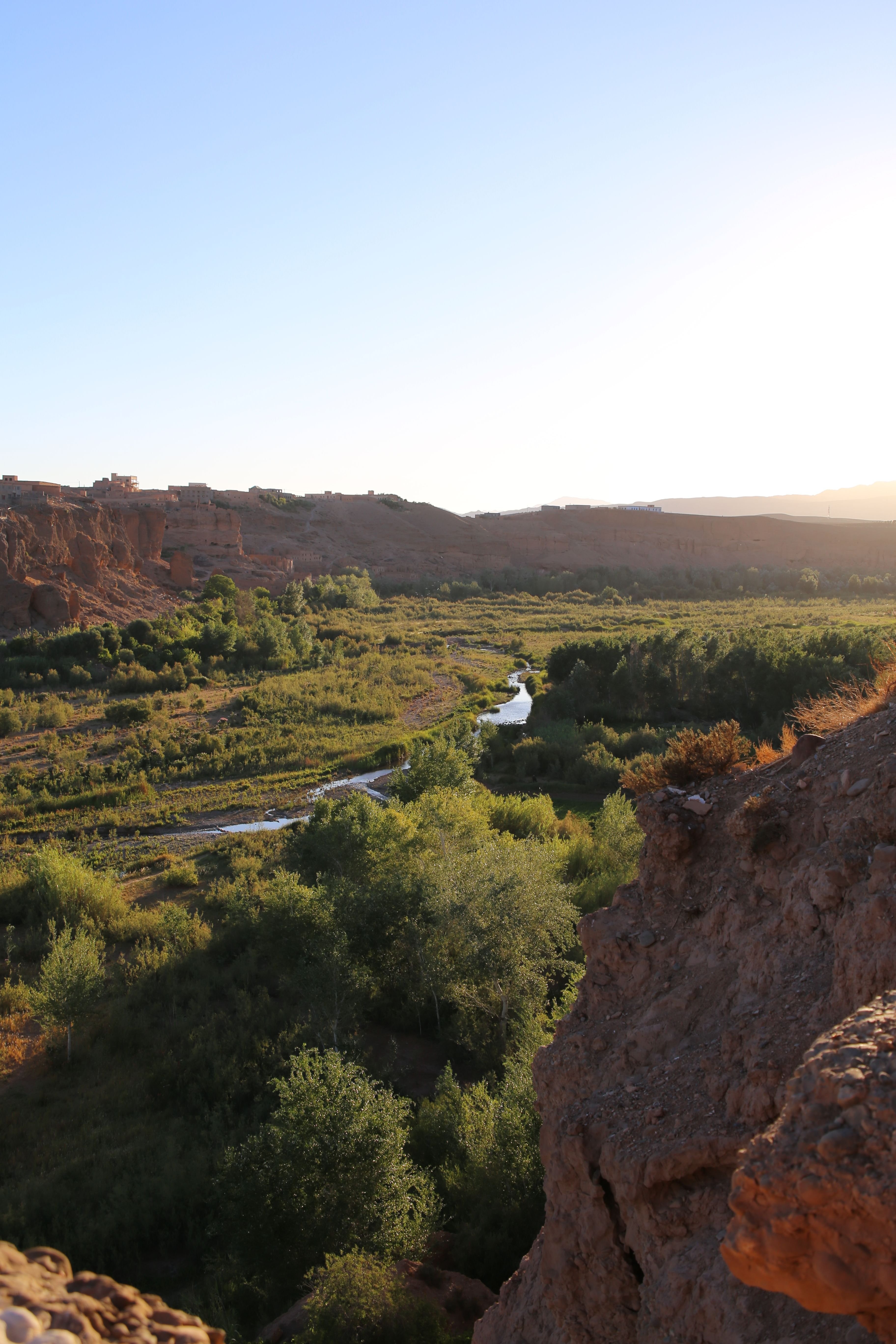 A 4x4 tour vehicle stopped at a viewpoint over Morocco's Dades Valley