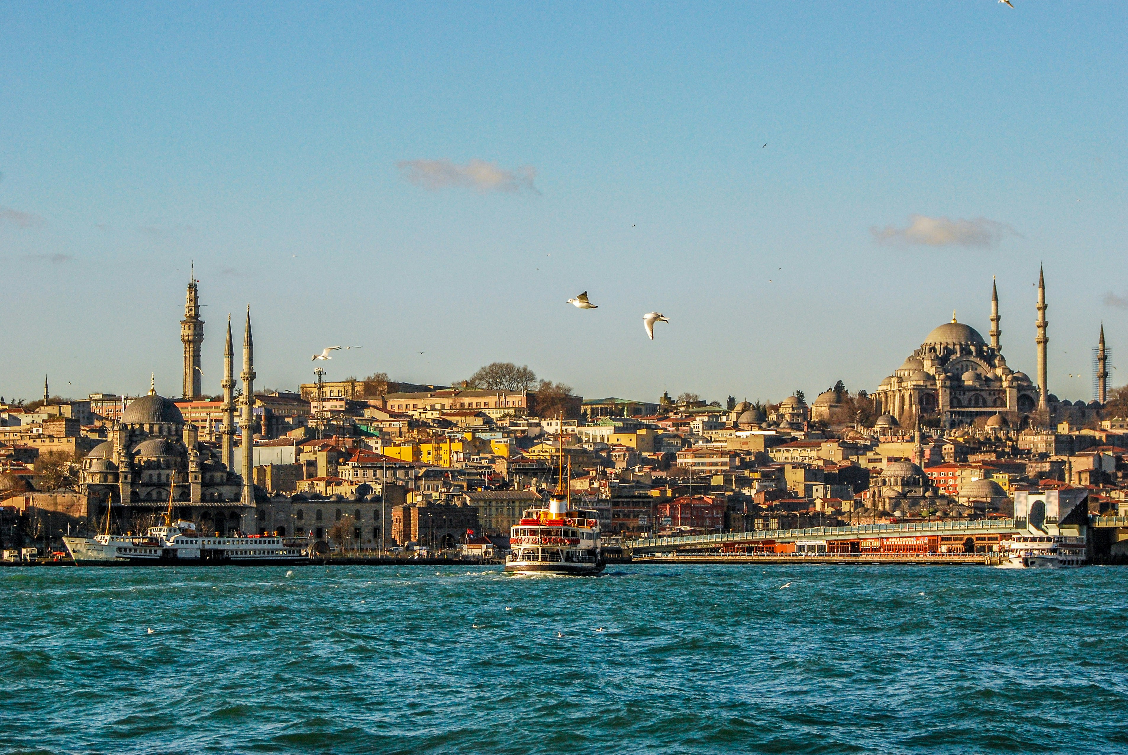 A montage-feel hero of Turkey — Istanbul skyline meeting Cappadocia balloons or the coast, no recognizable faces