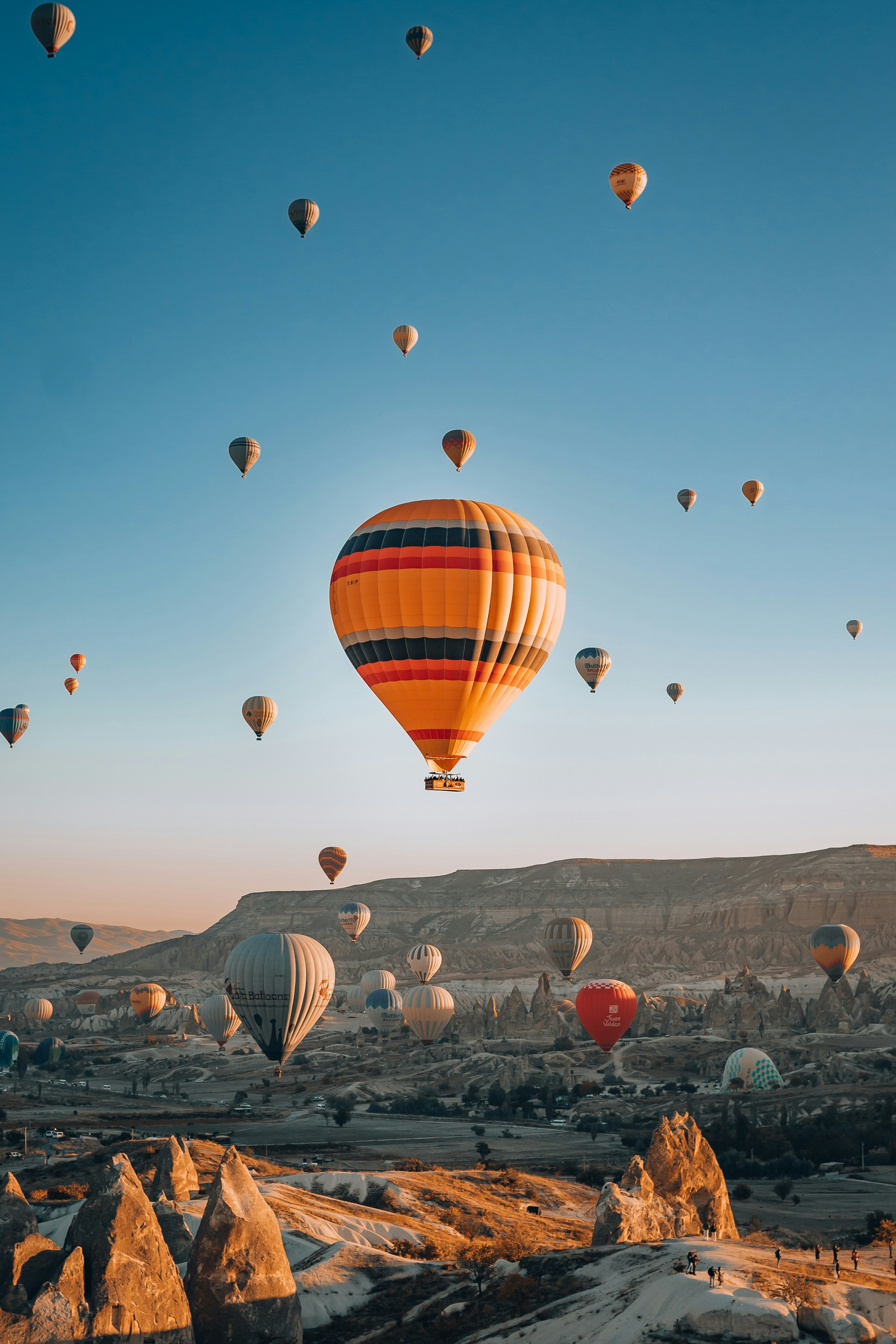 Cappadocia balloons rising over the fairy chimneys at sunrise