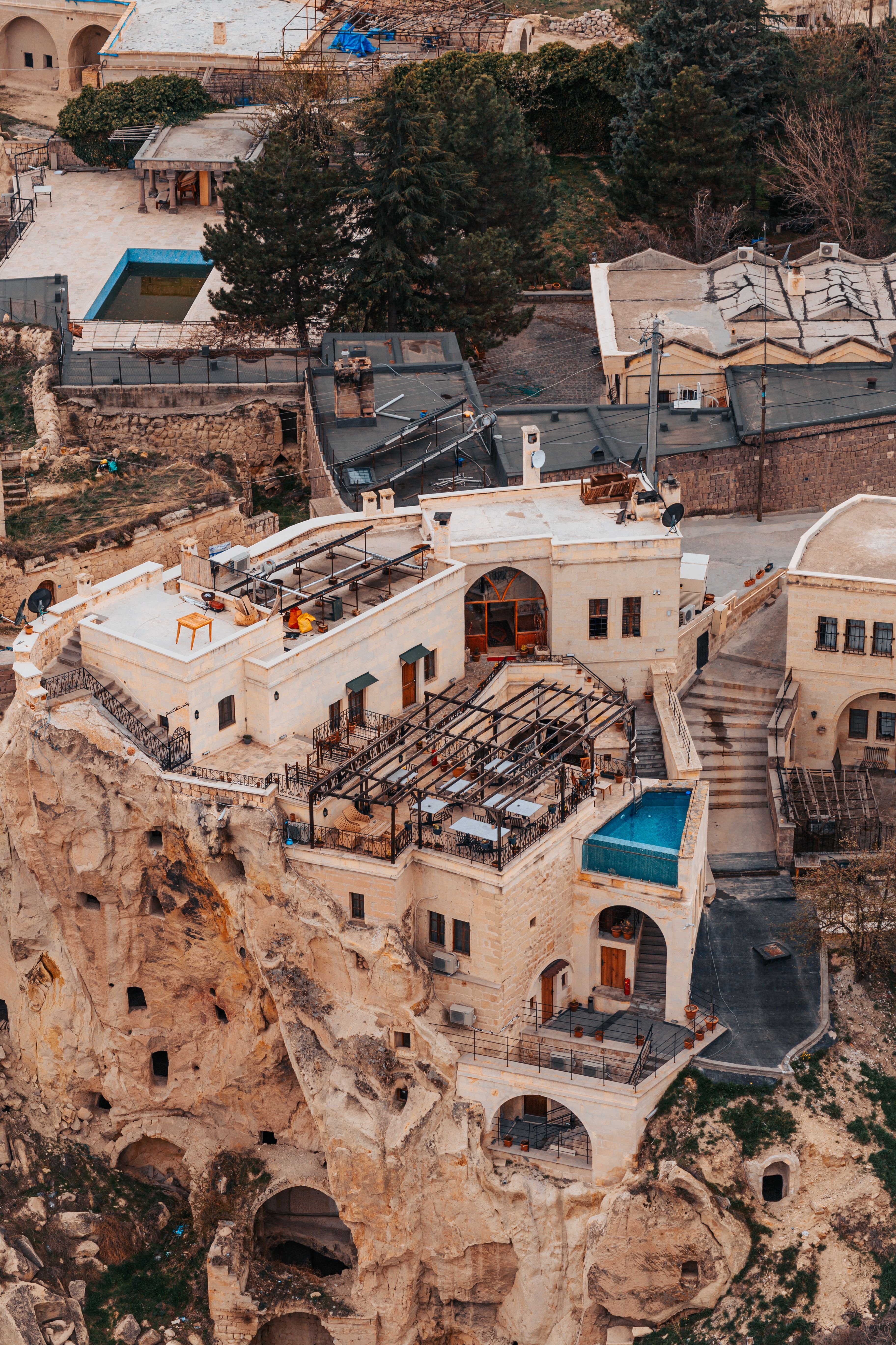 A characterful boutique hotel courtyard or terrace in Turkey — Ottoman details, plants, warm light, no recognizable faces