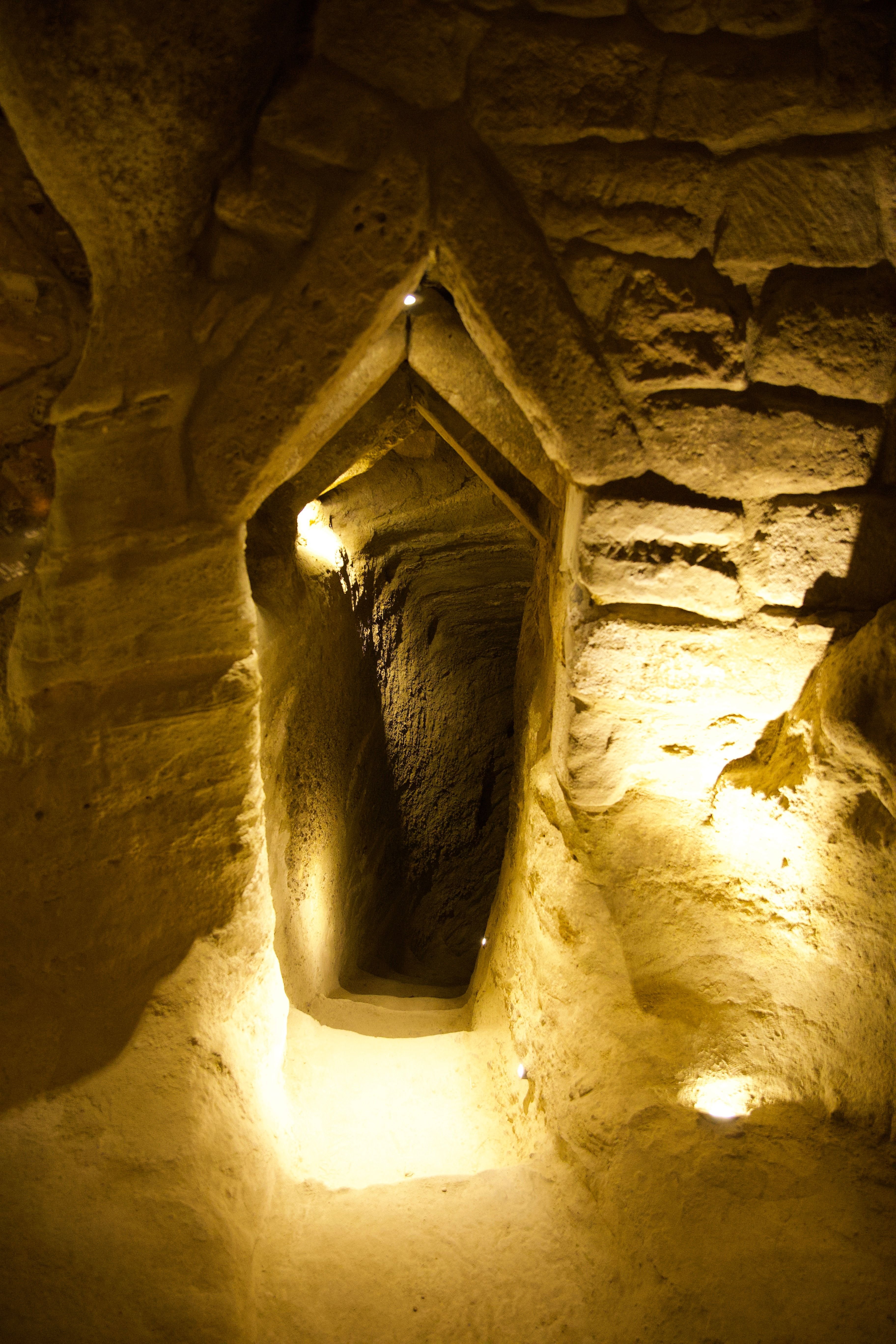 Interior of a multi-level underground city with carved stone passages and stairs
