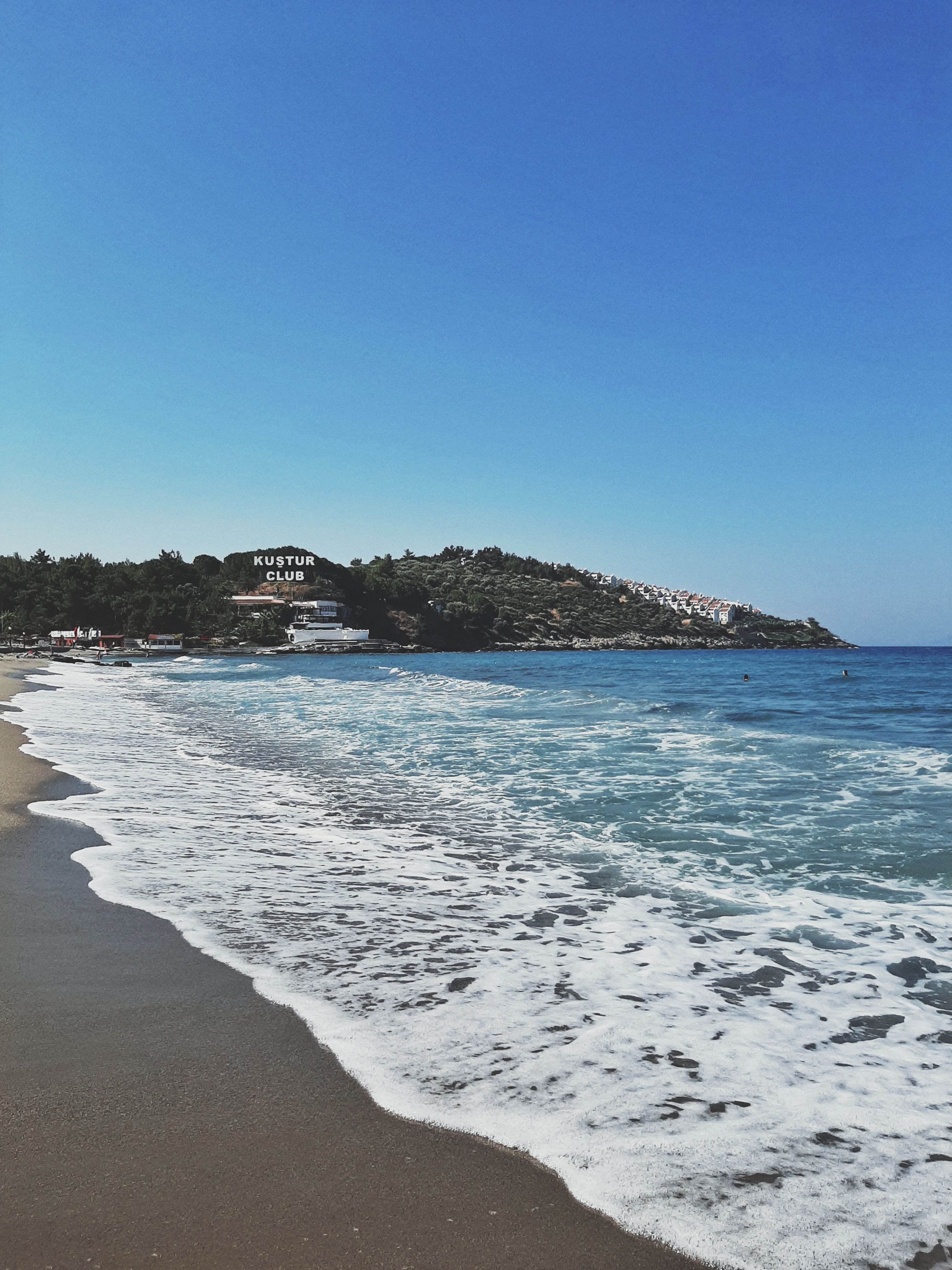Pigeon Island fortress connected by causeway at Kusadasi, blue Aegean water