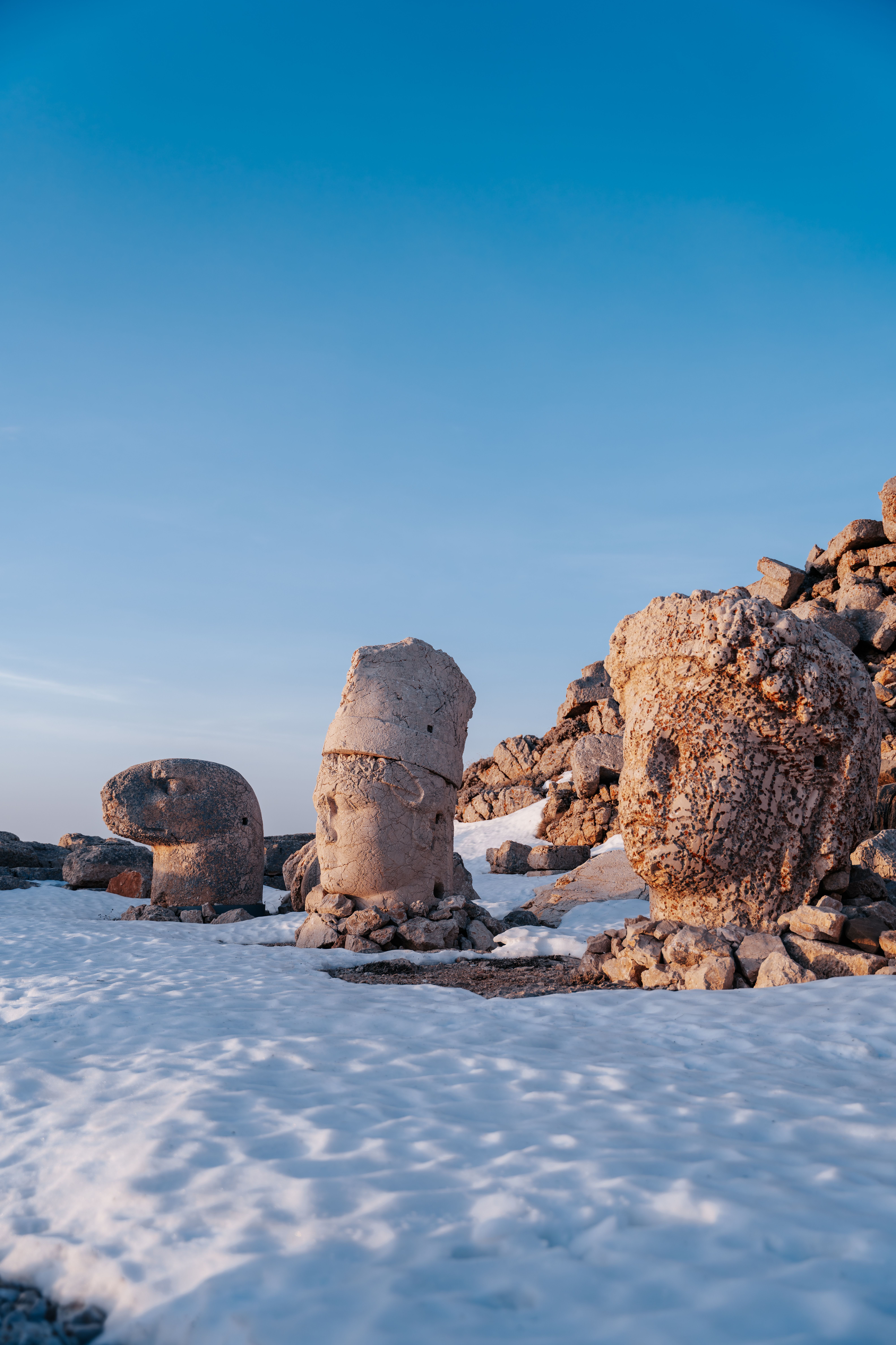 The giant toppled stone heads of Mount Nemrut at sunrise, mountain panorama, no recognizable faces