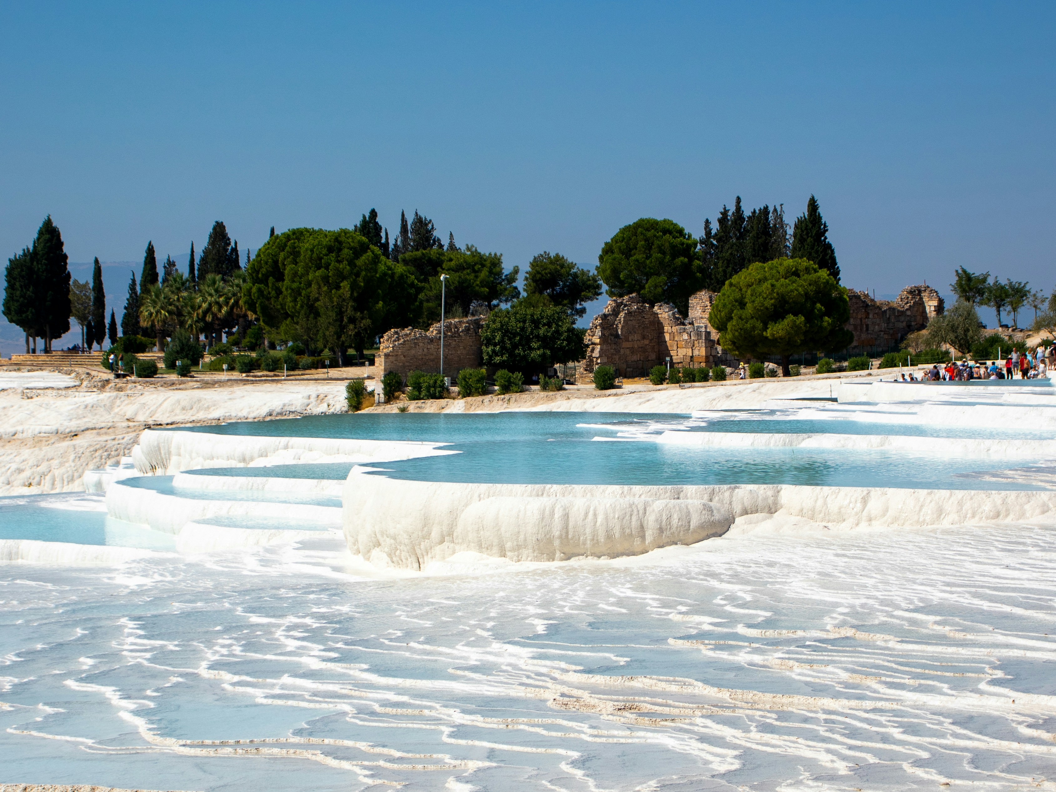The white travertine terraces of Pamukkale with turquoise pools cascading downhill