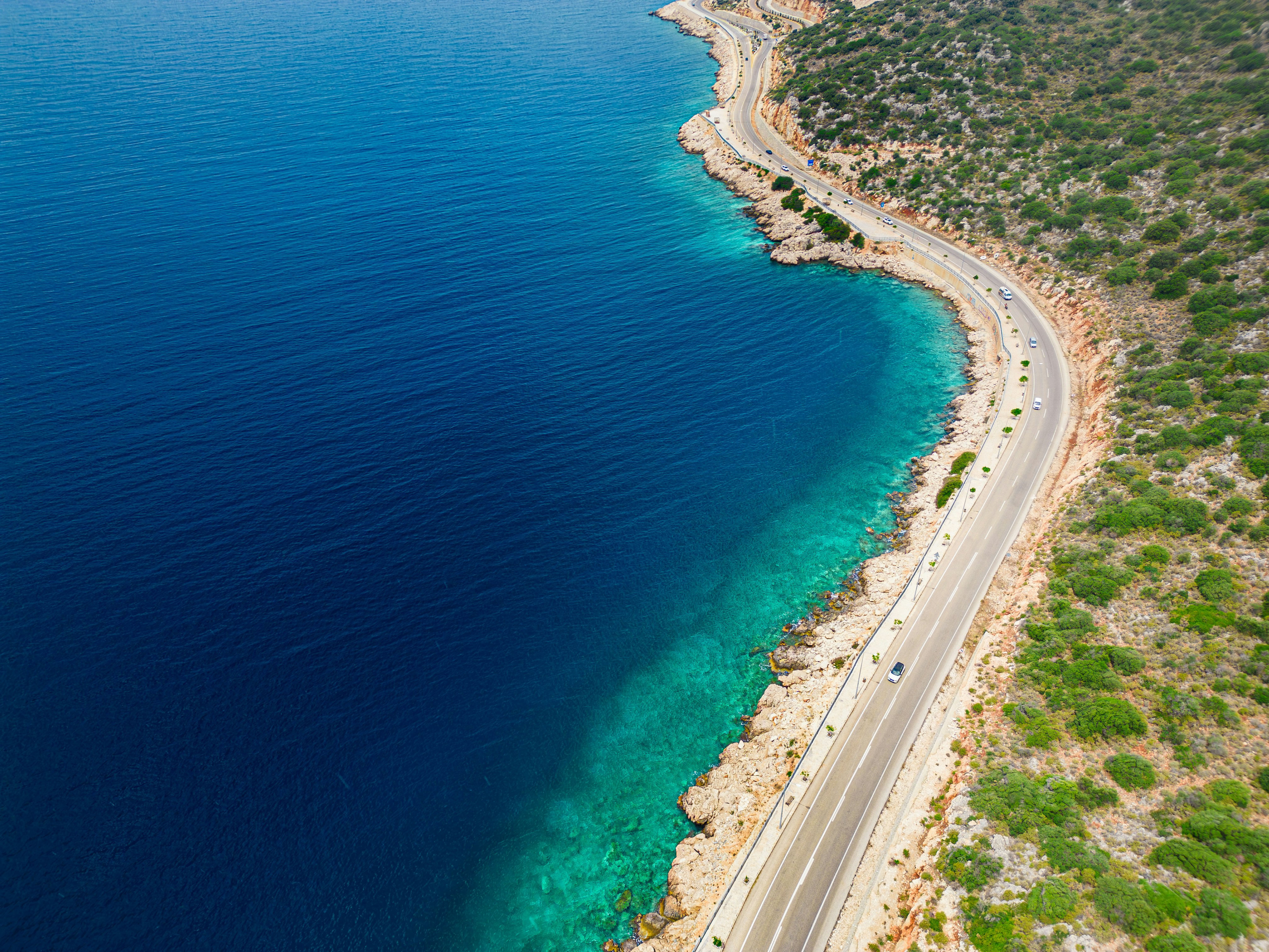 A car on a scenic Turkish coastal or Cappadocia road, no recognizable faces