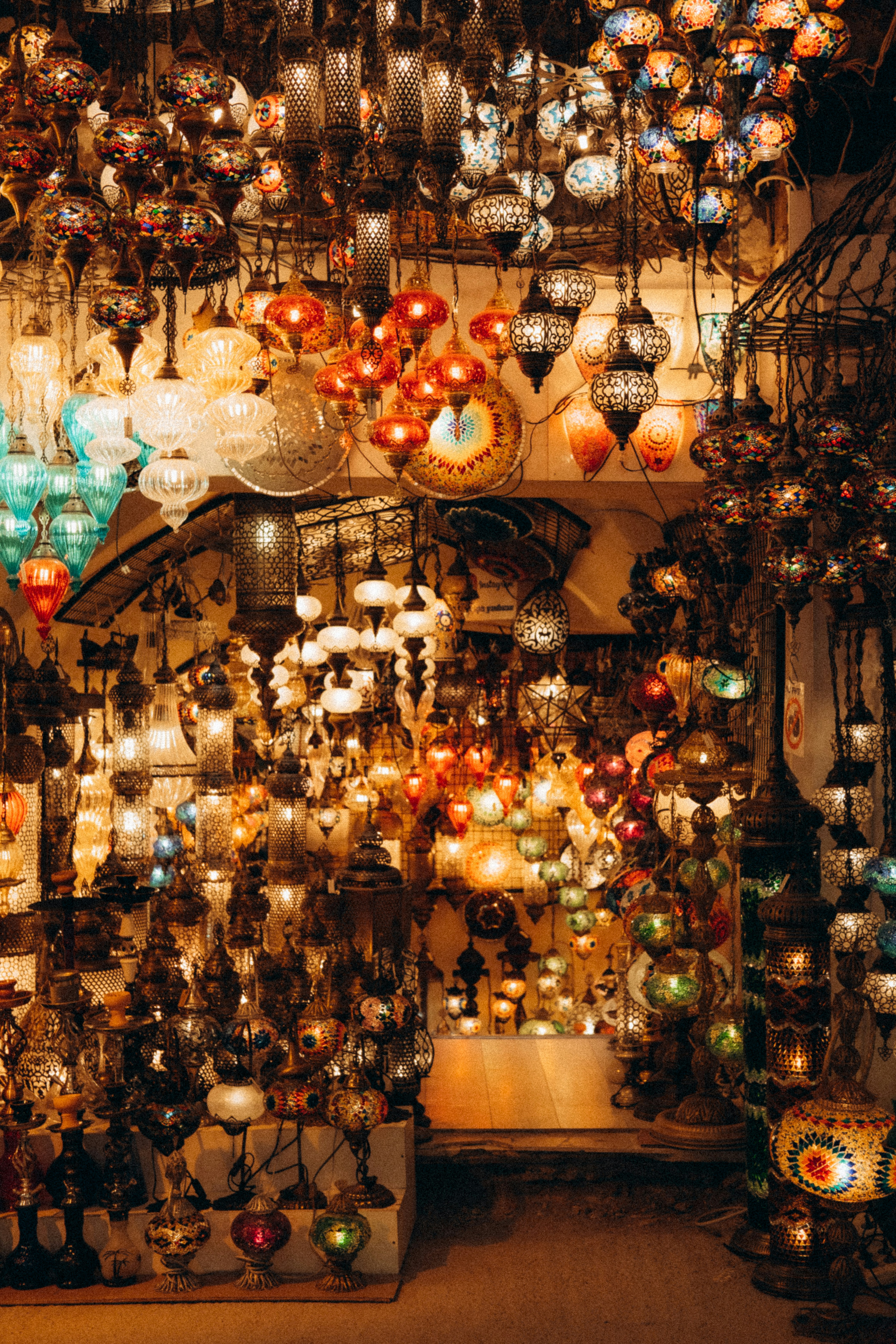 A colorful Turkish bazaar interior — hanging lamps, spices, and textiles, no recognizable faces
