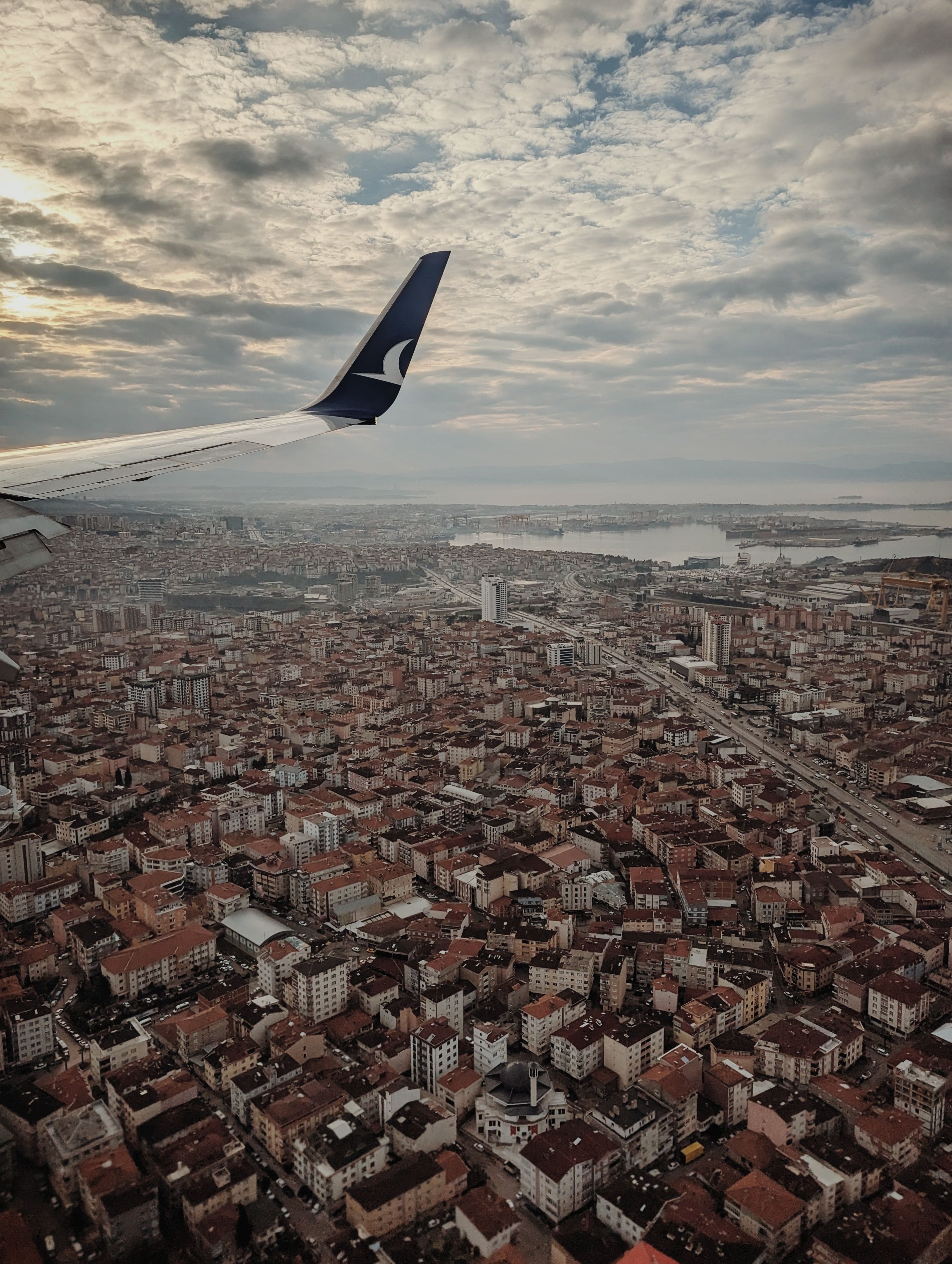 A departures board or a view of planes at a busy Turkish airport