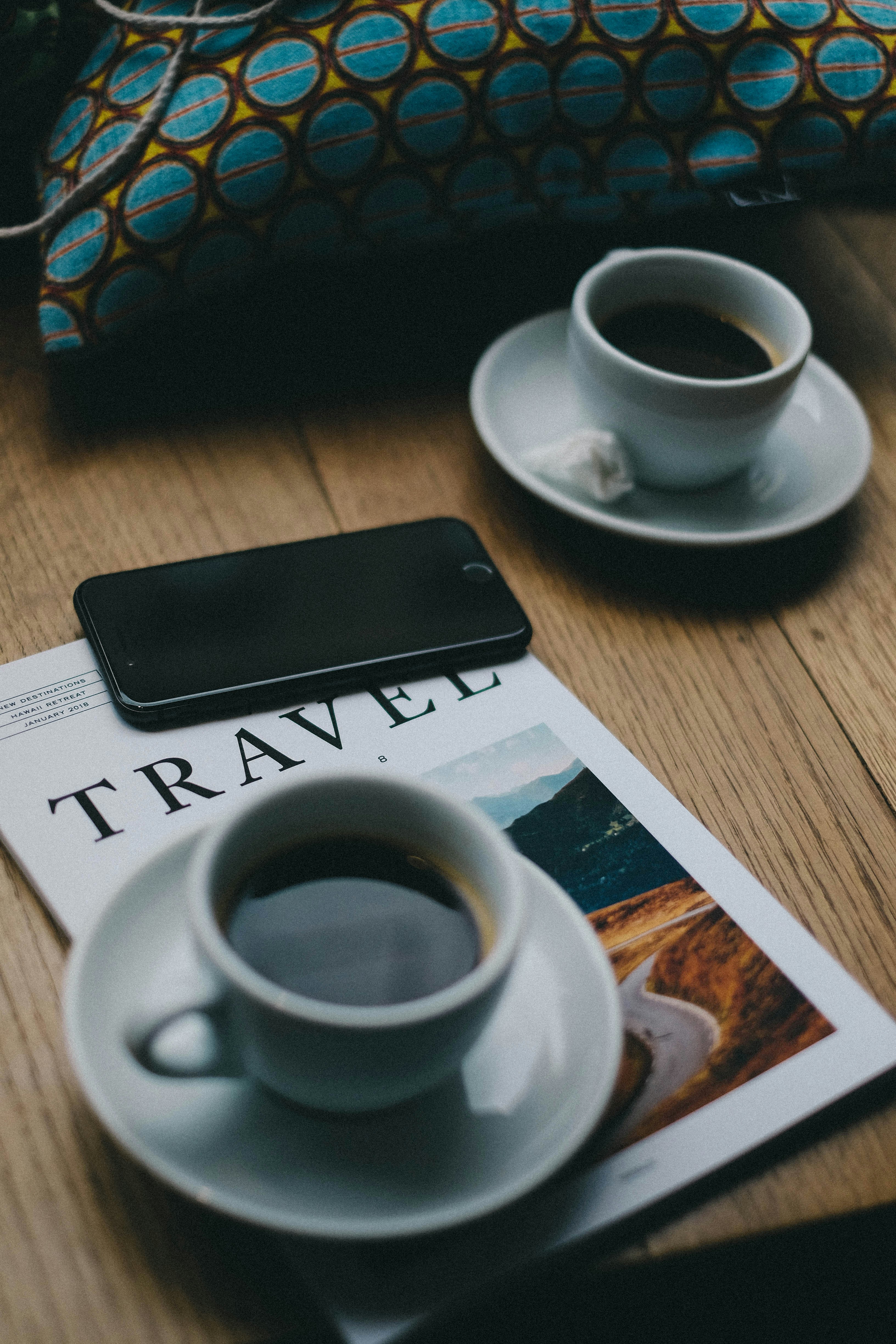 A smartphone showing a map or travel app held up in a Turkish street scene, no recognizable faces