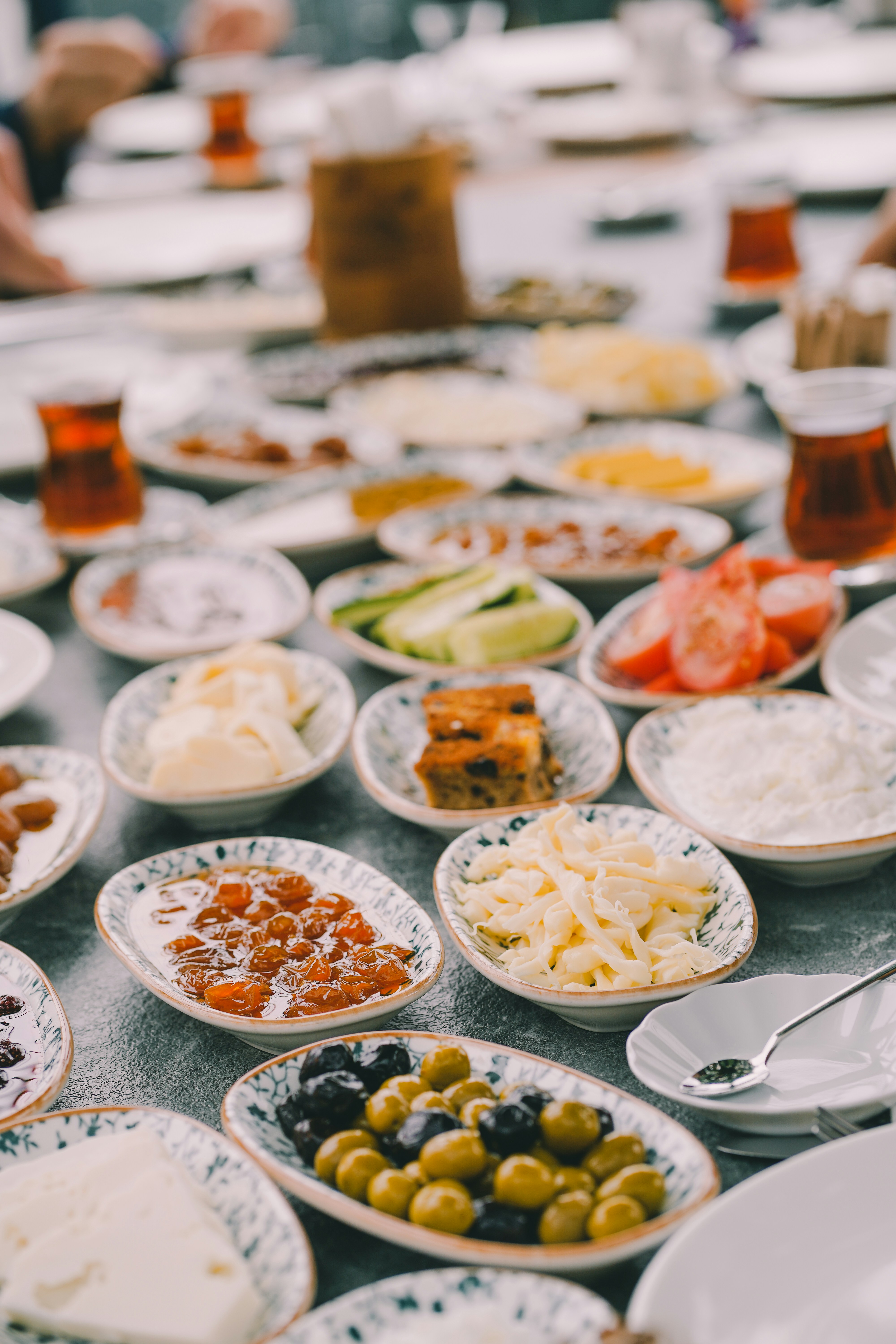A traditional Turkish breakfast spread with cheeses, olives, eggs, jams, and tea