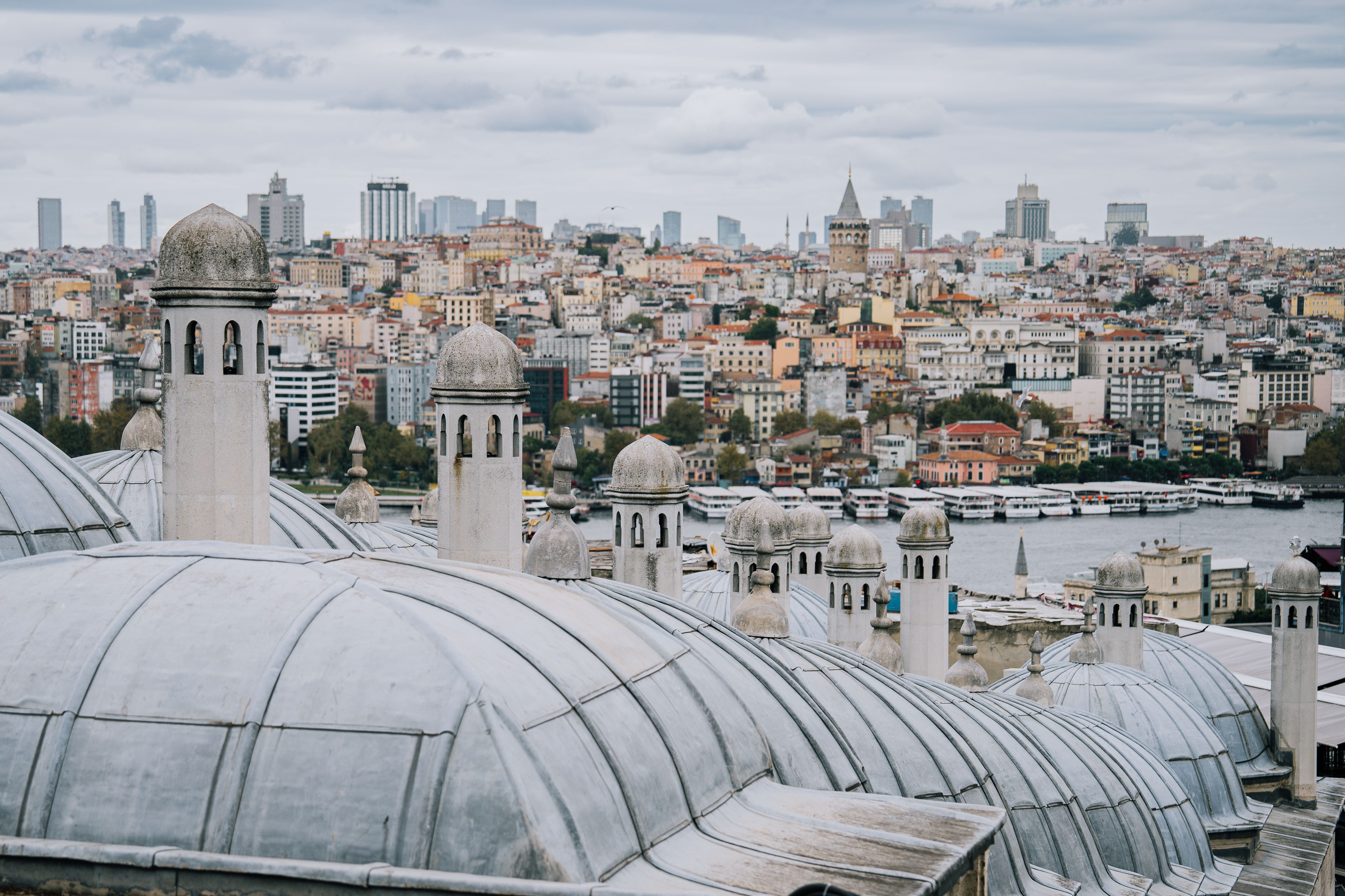 Rooftop terrace view over Sultanahmet with the Blue Mosque domes and minarets at dusk