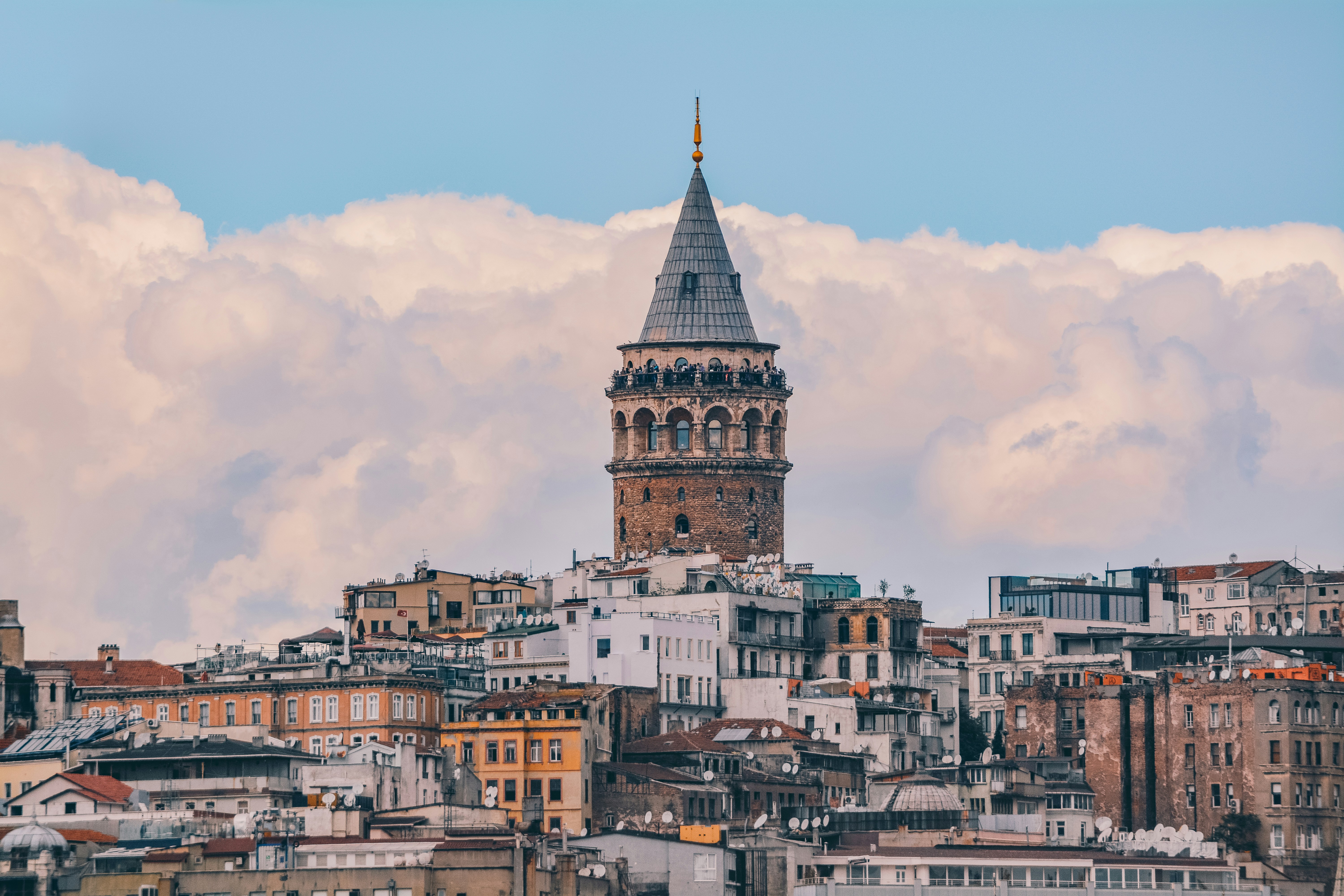 Galata Tower rising above the rooftops of Beyoğlu, seen from a cafe terrace